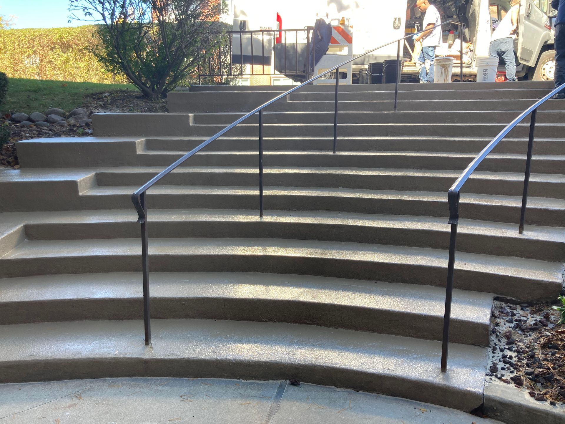 a set of curved stairs with a metal railing