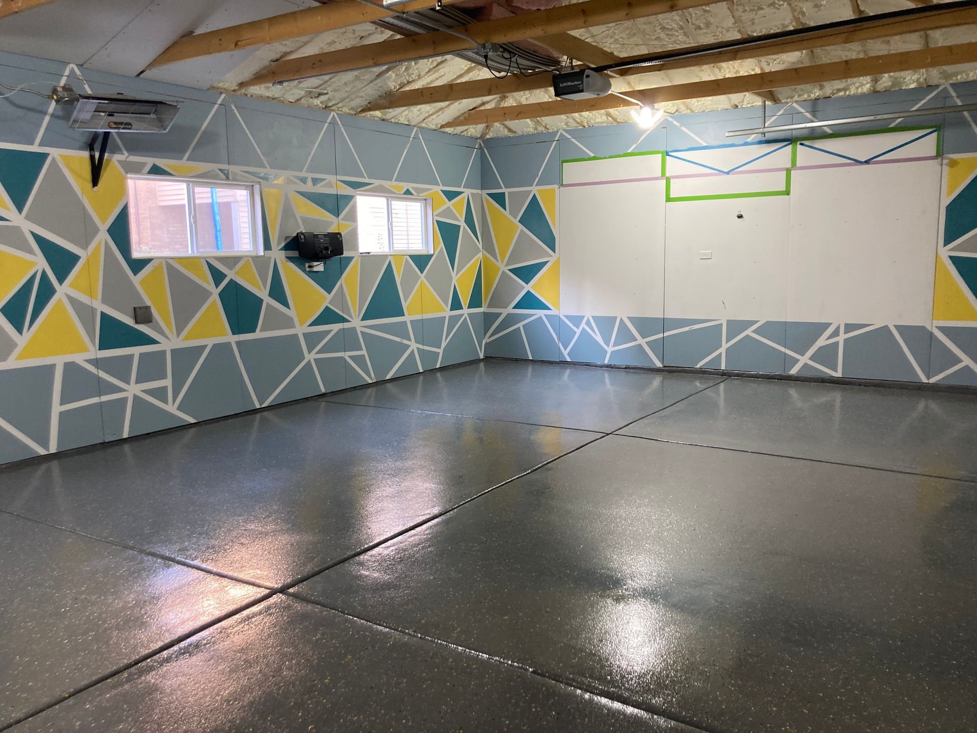 an empty garage with a geometric pattern on the walls