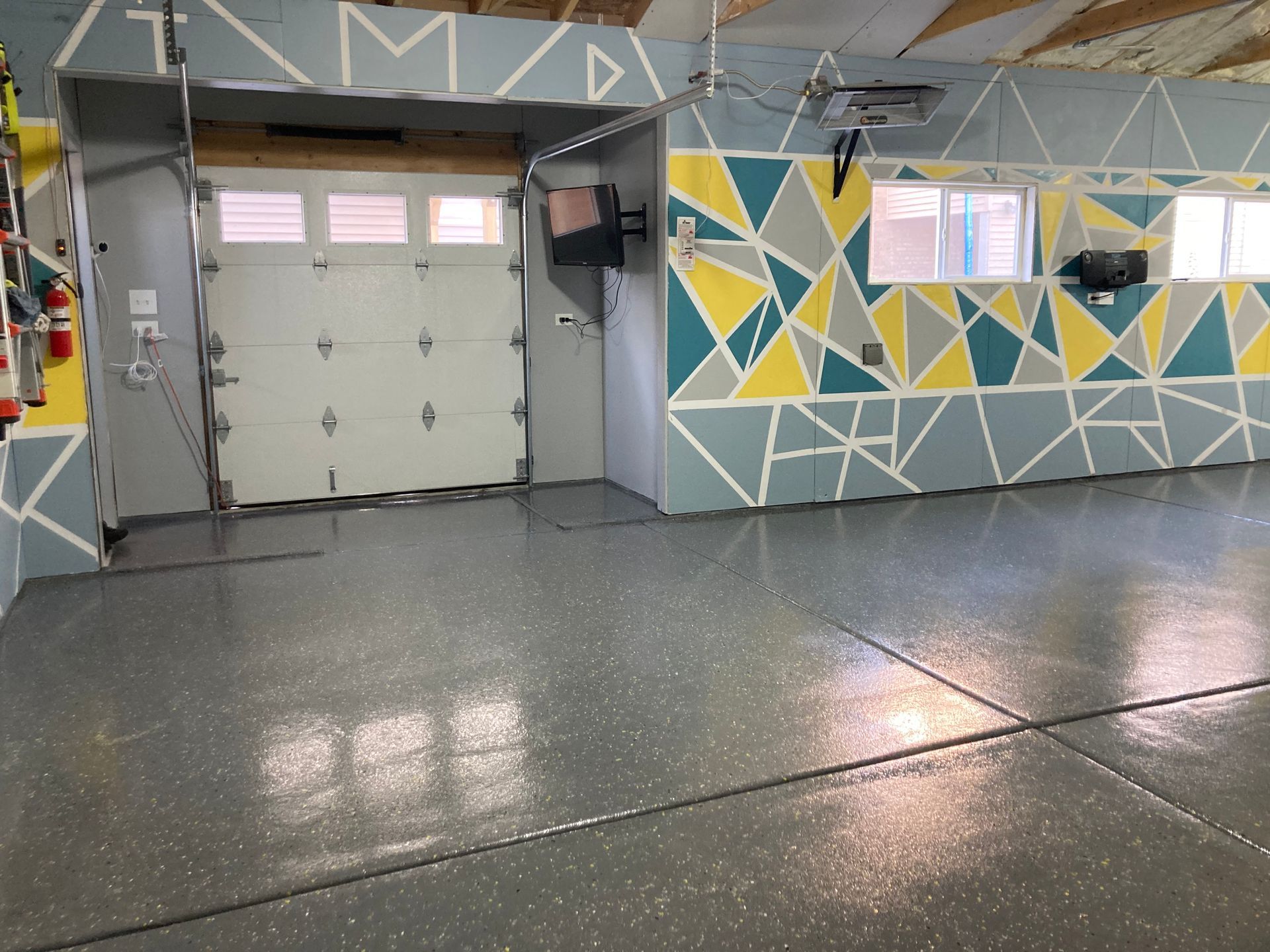 a garage with a painted wall and a garage door