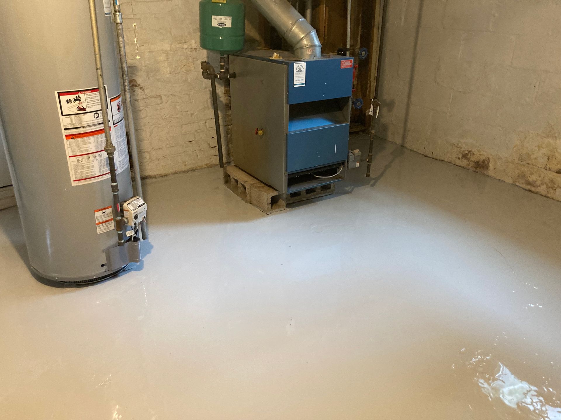 there is a water heater and a boiler in the basement