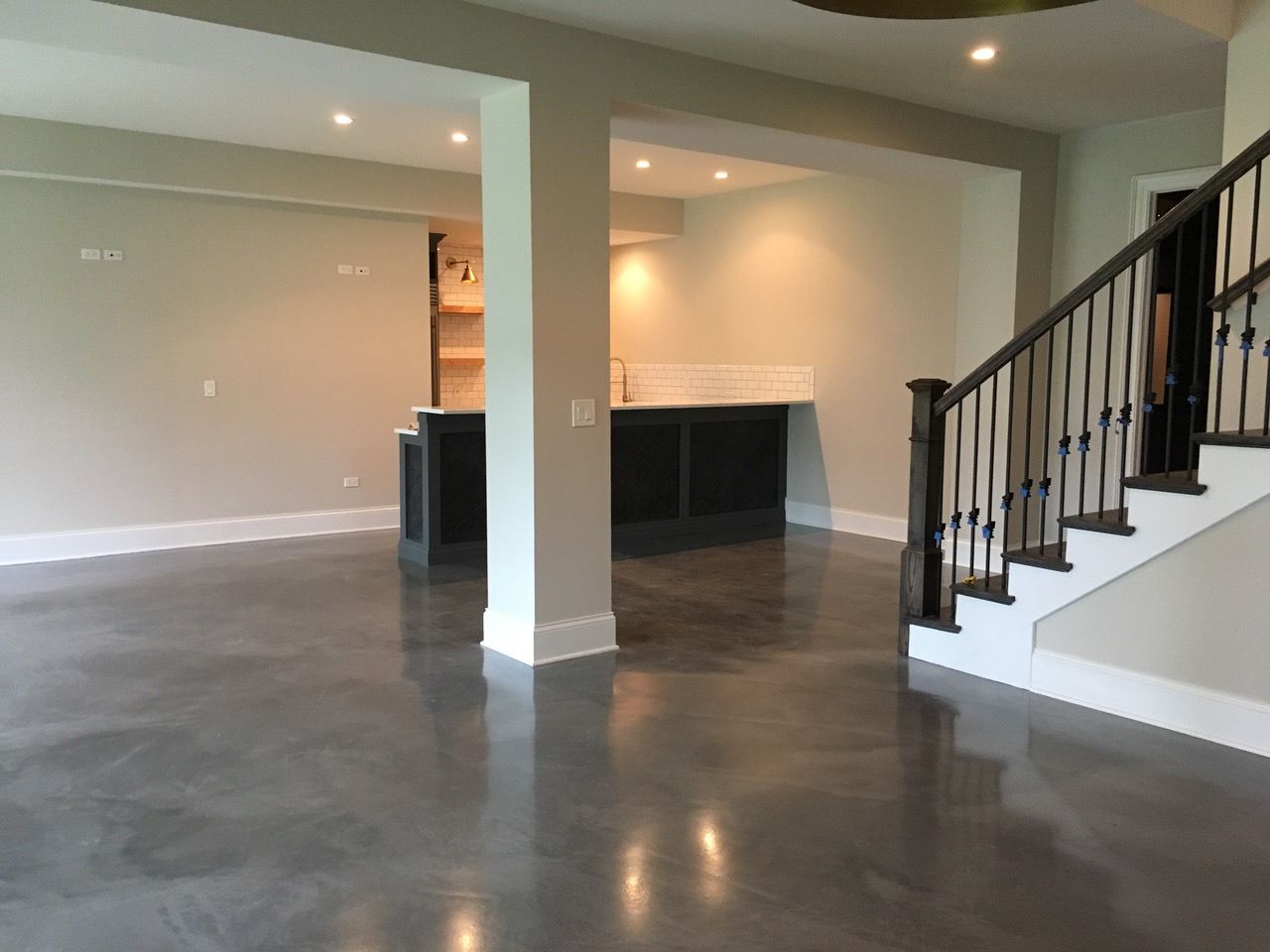 an empty basement with stairs leading up to the second floor