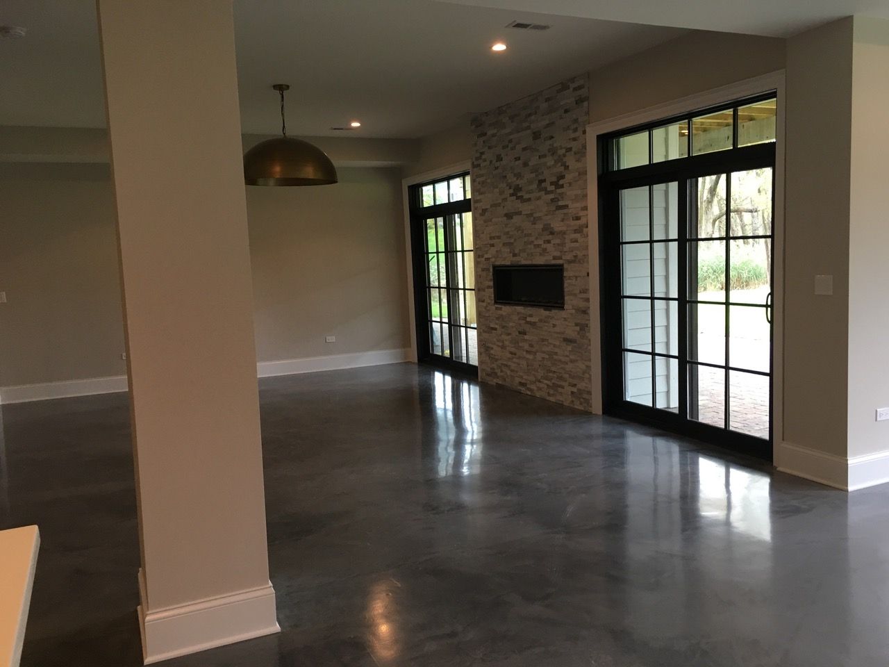an empty room with sliding glass doors and a fireplace