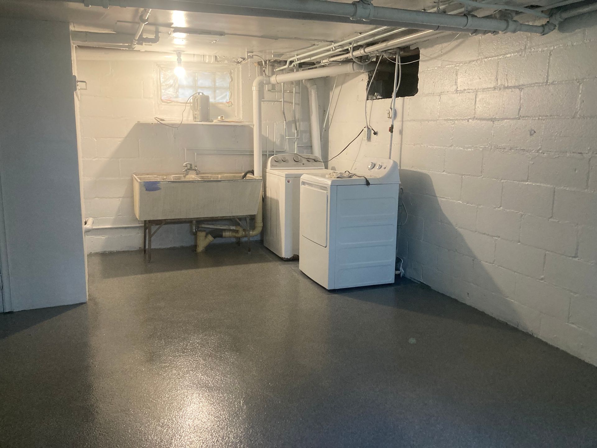 a laundry room with a washer and dryer and a sink