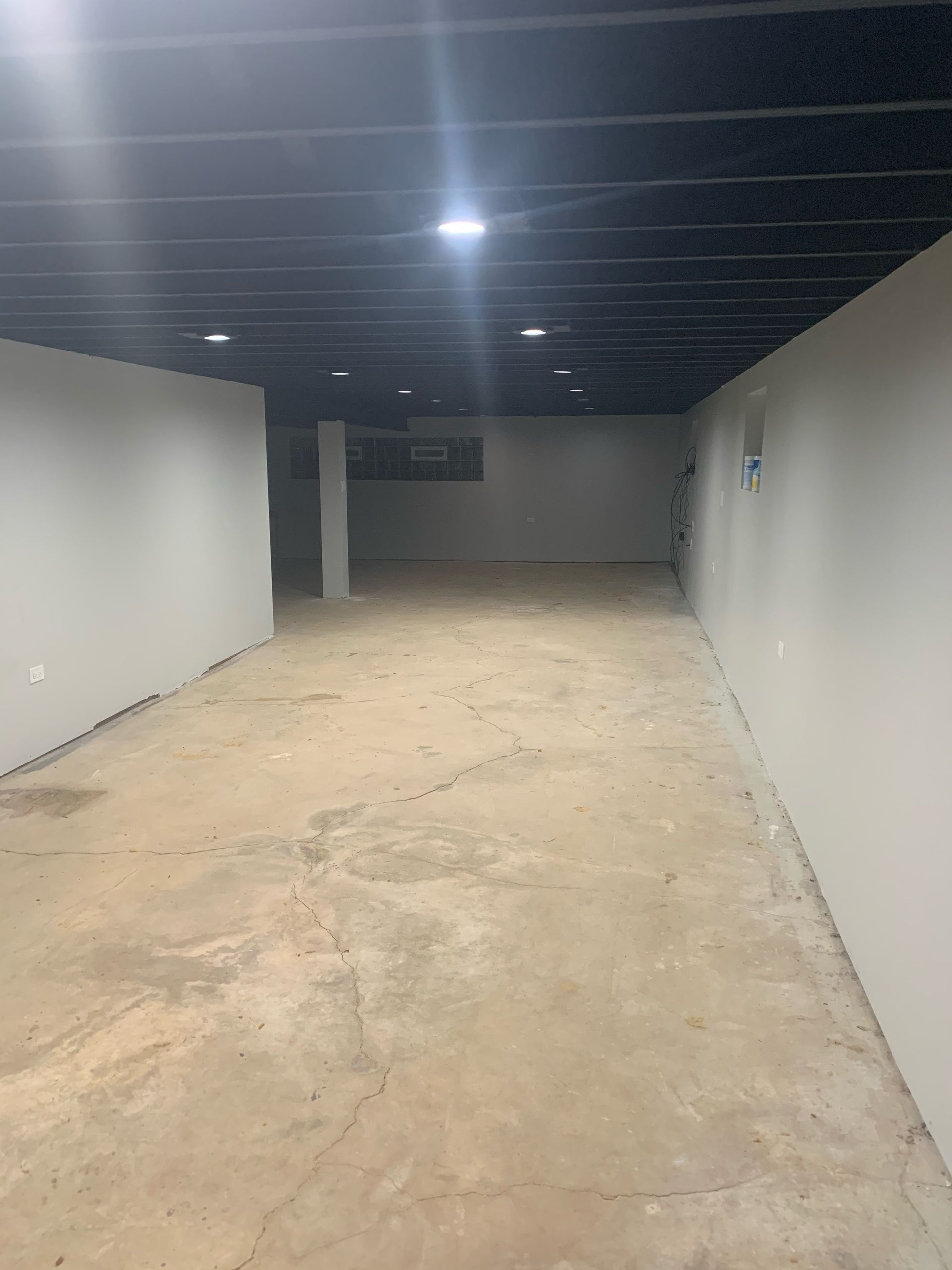 a large empty room with a dark ceiling and white walls