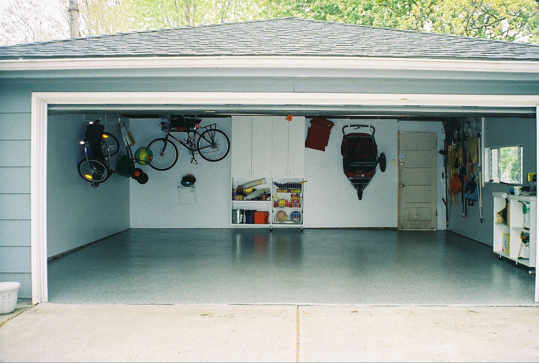 a garage with two bikes hanging on the wall