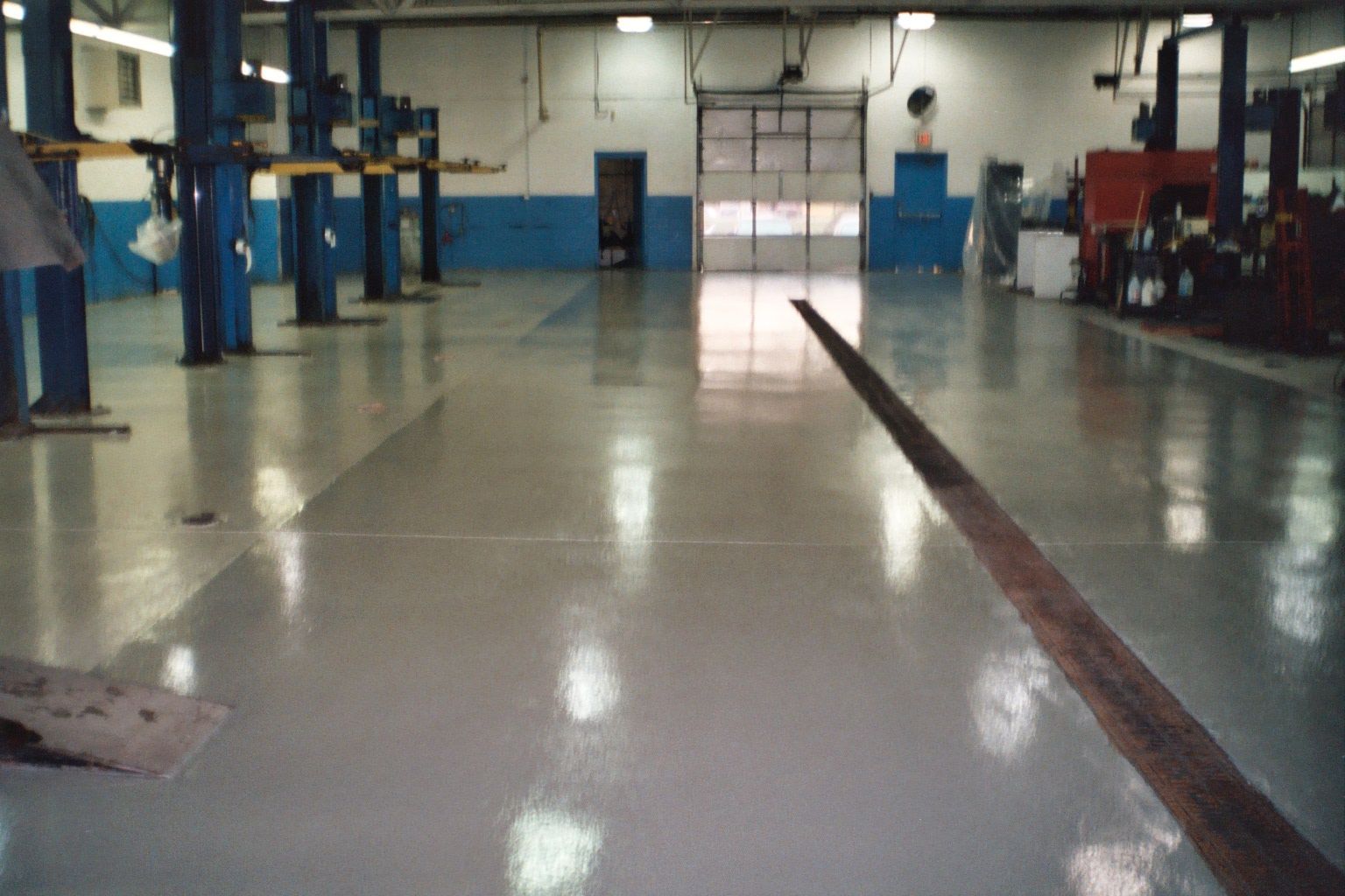 a large garage with a lot of lifts in it