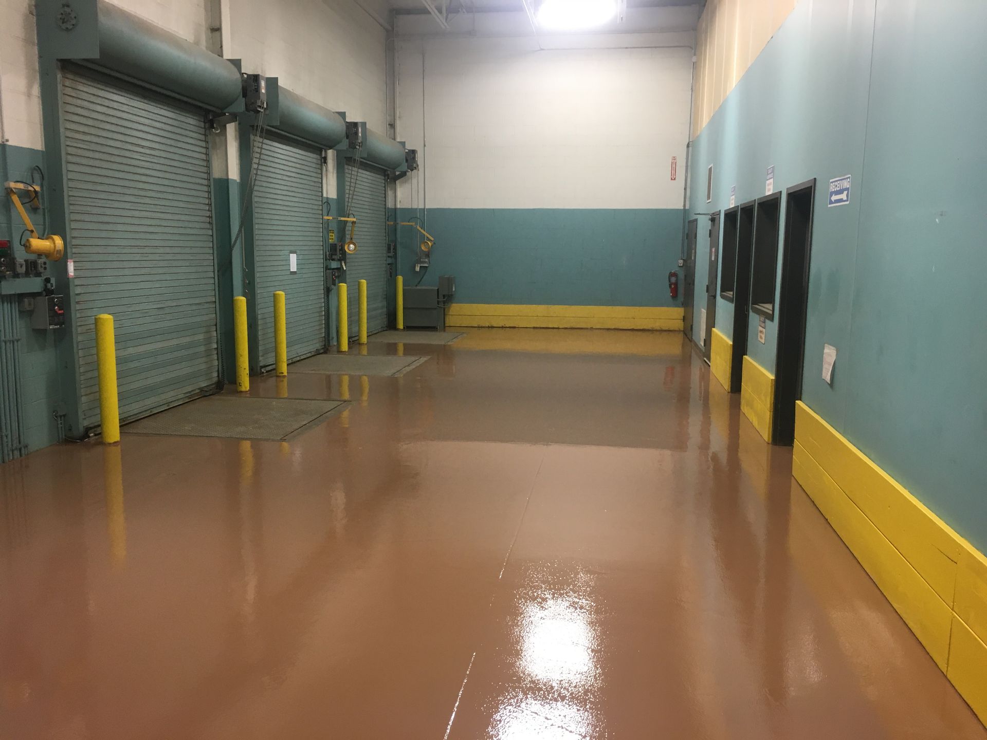 a large warehouse with lots of doors and a shiny floor