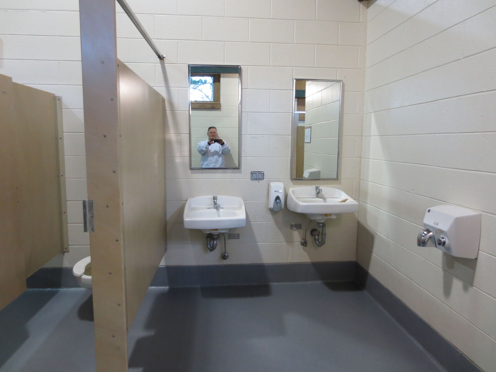 a bathroom with two sinks and two mirrors