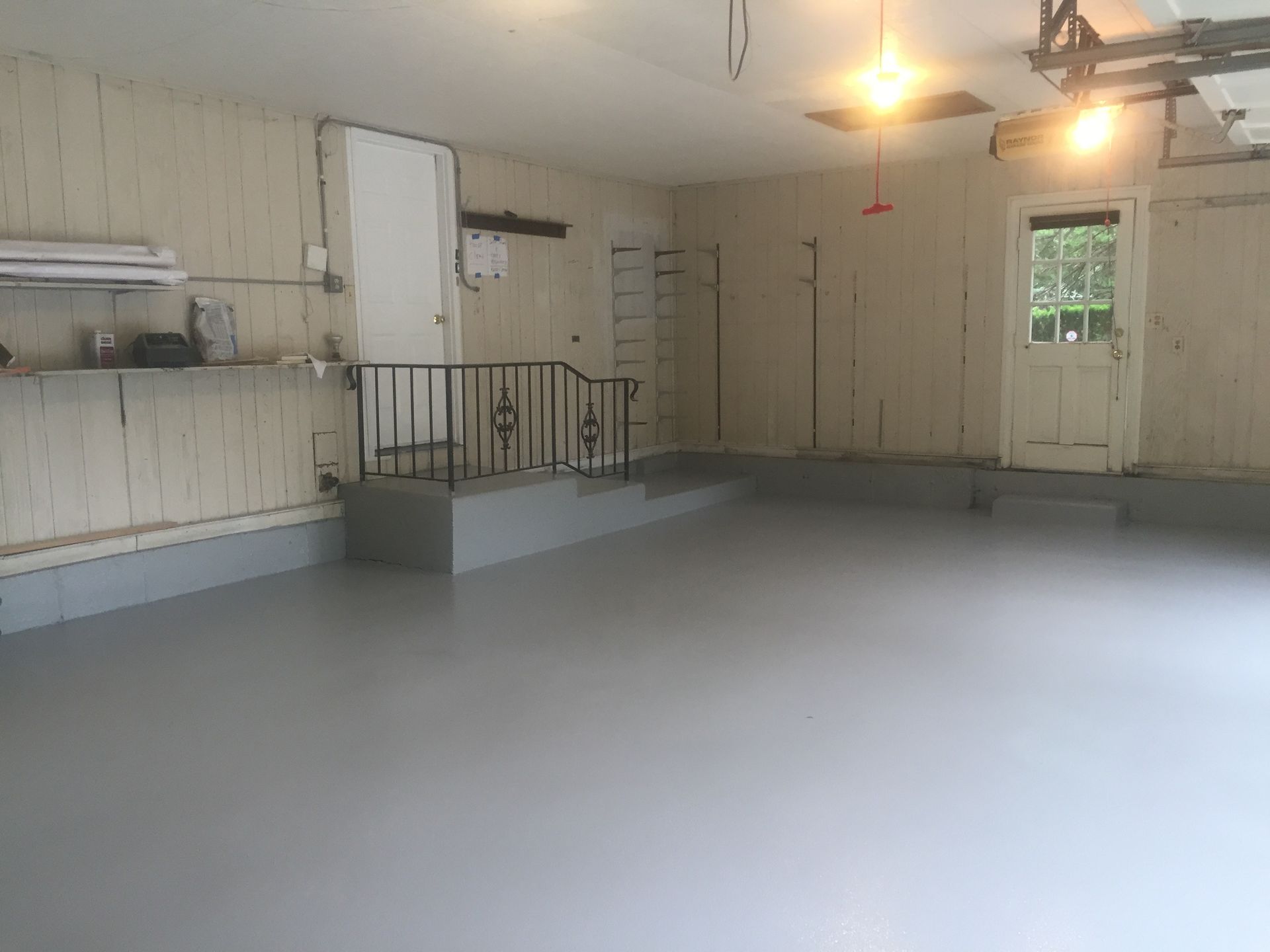 a large empty garage with a staircase and a door