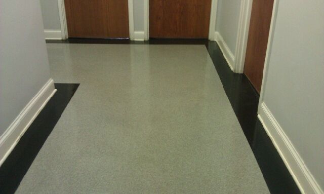 a hallway with a black border and a wooden door