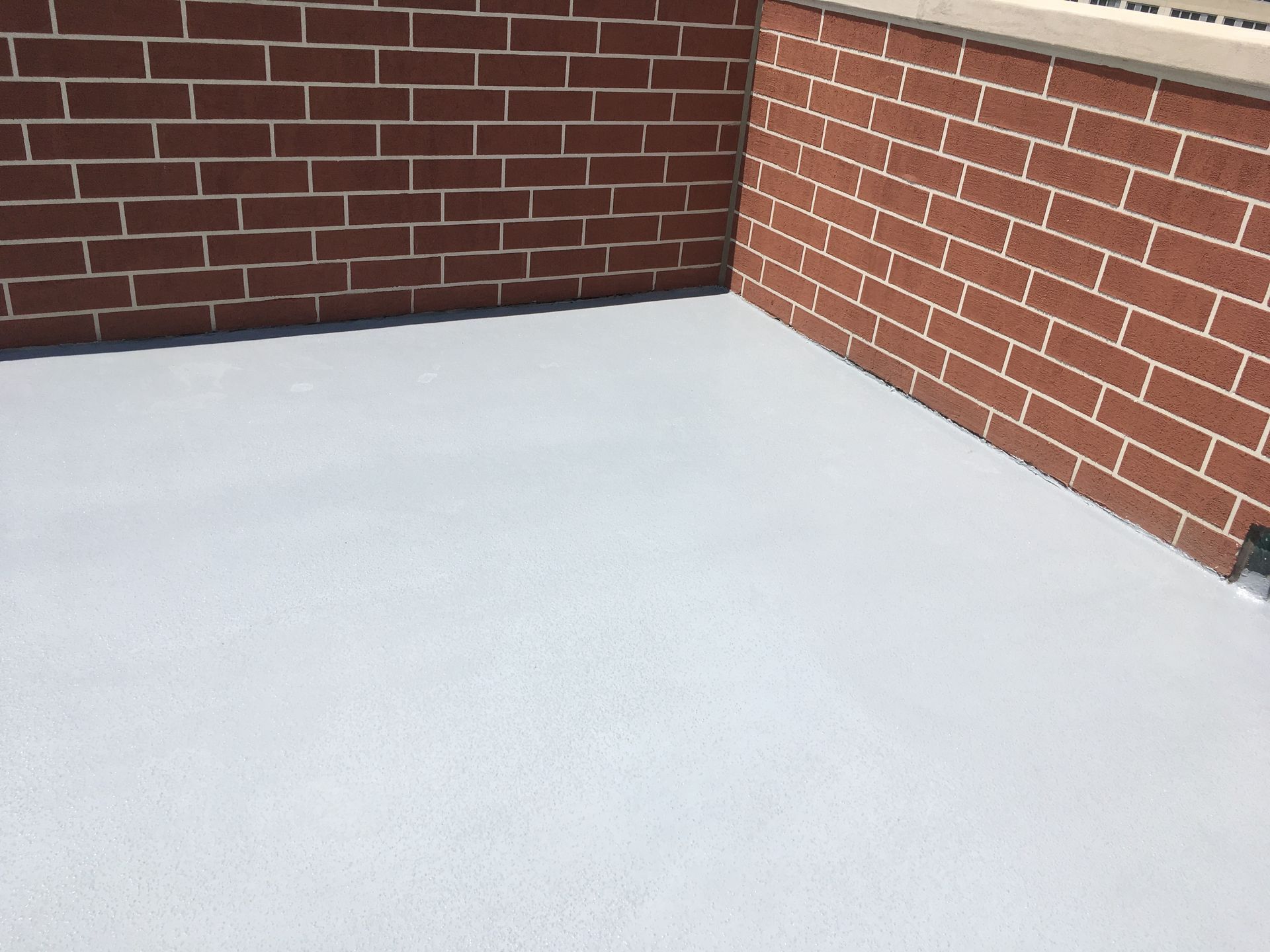 a brick wall with a white floor in front of it