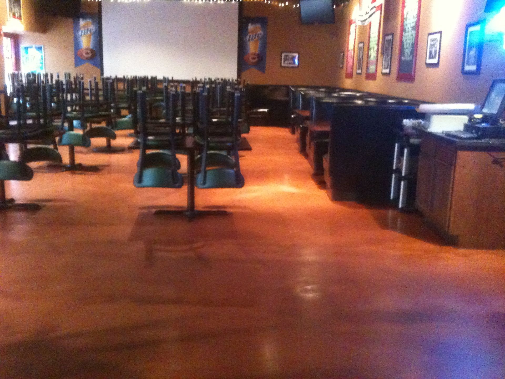 a row of tables and chairs in an empty restaurant