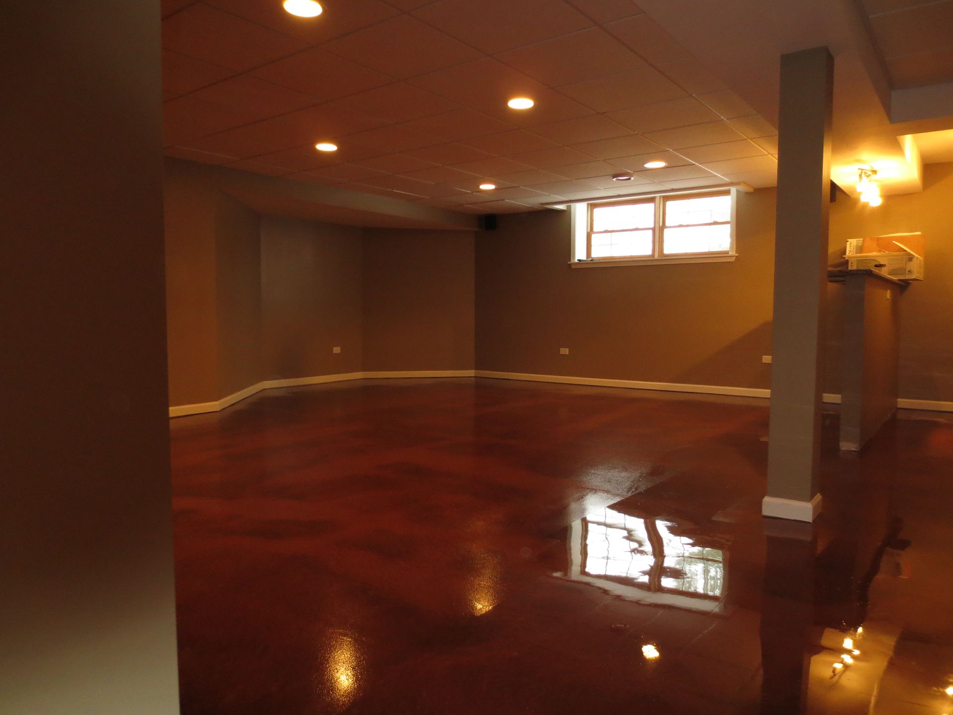 an empty room with a wooden floor and a window