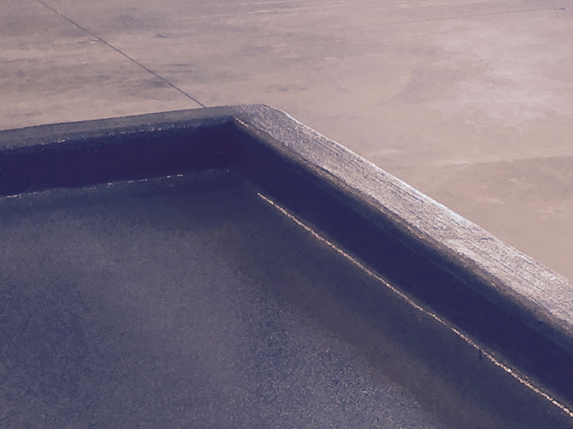 a blue tray is sitting on a concrete surface