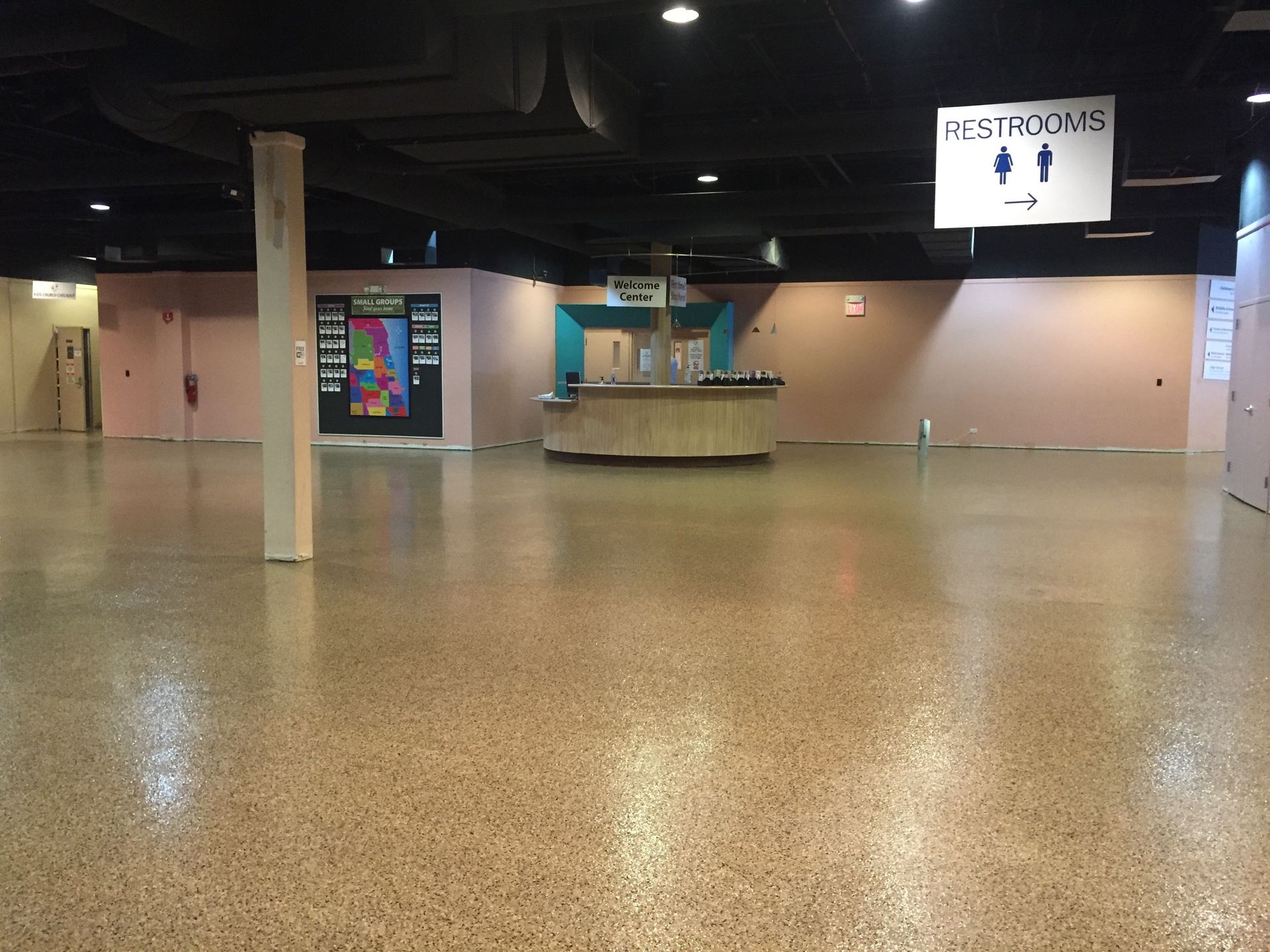 an empty room with a sign above it that says restrooms