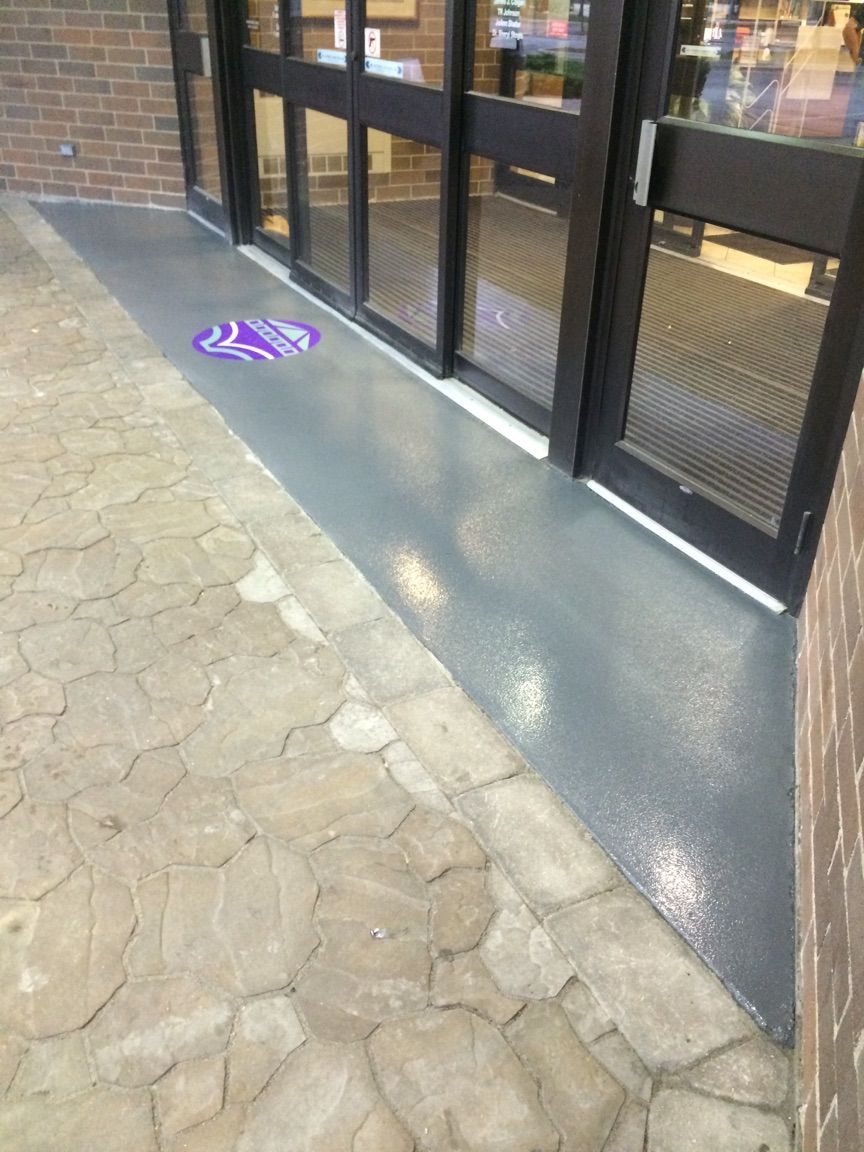 a doorway with a purple sign on the ground in front of it