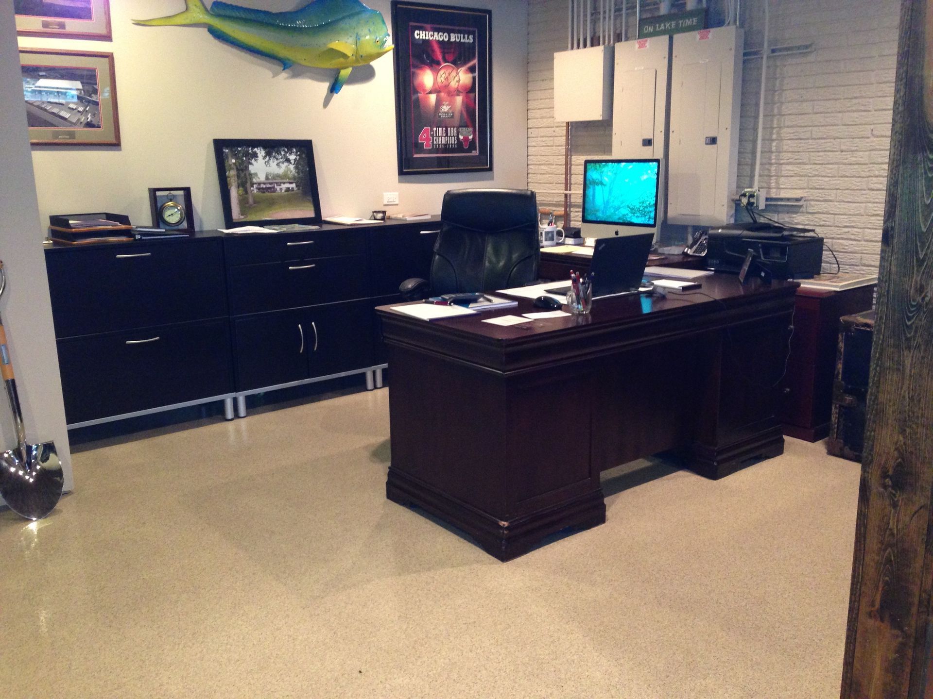 an office with a large fish on the wall above the desk