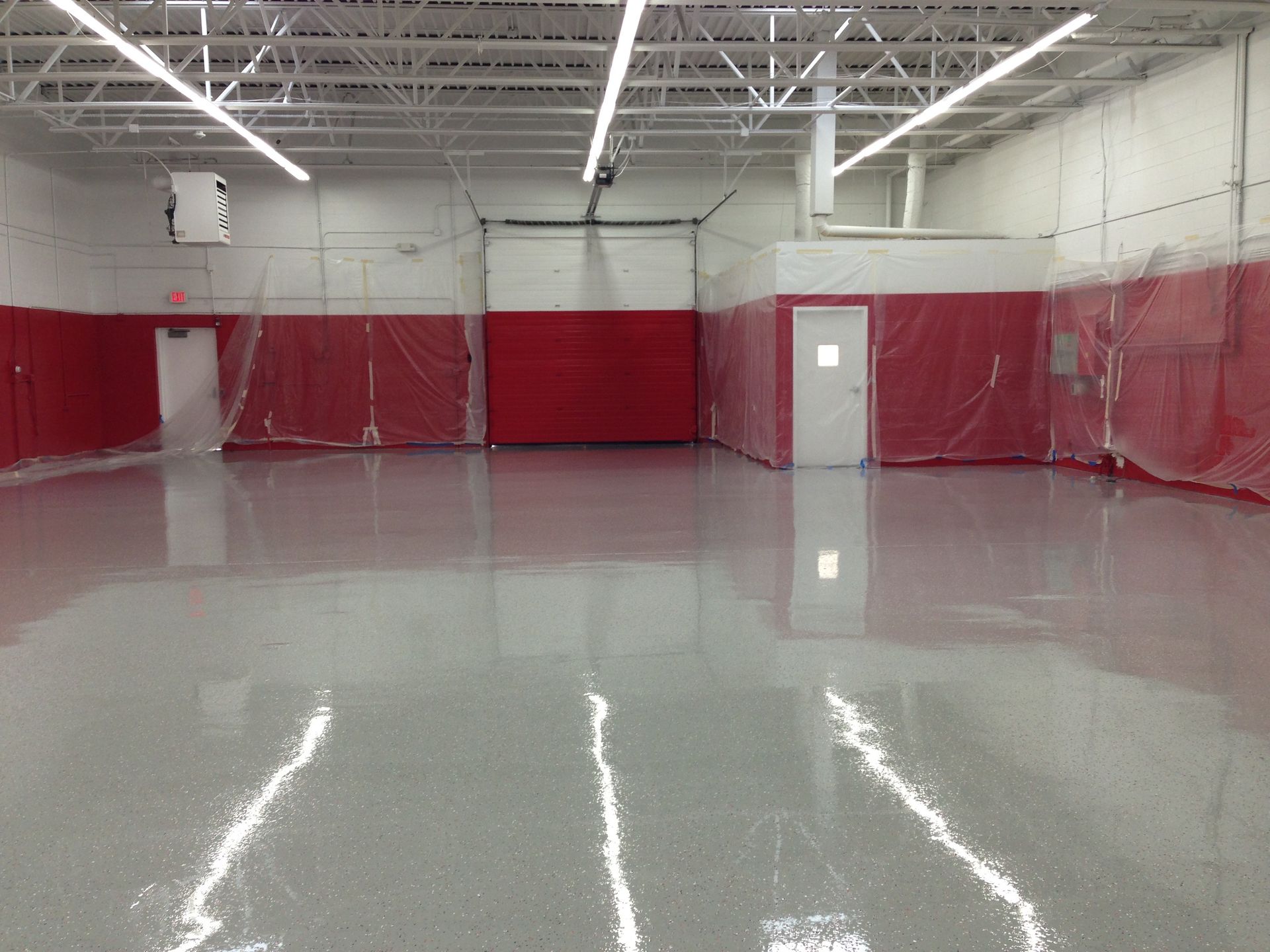 a large room with a shiny floor and red walls