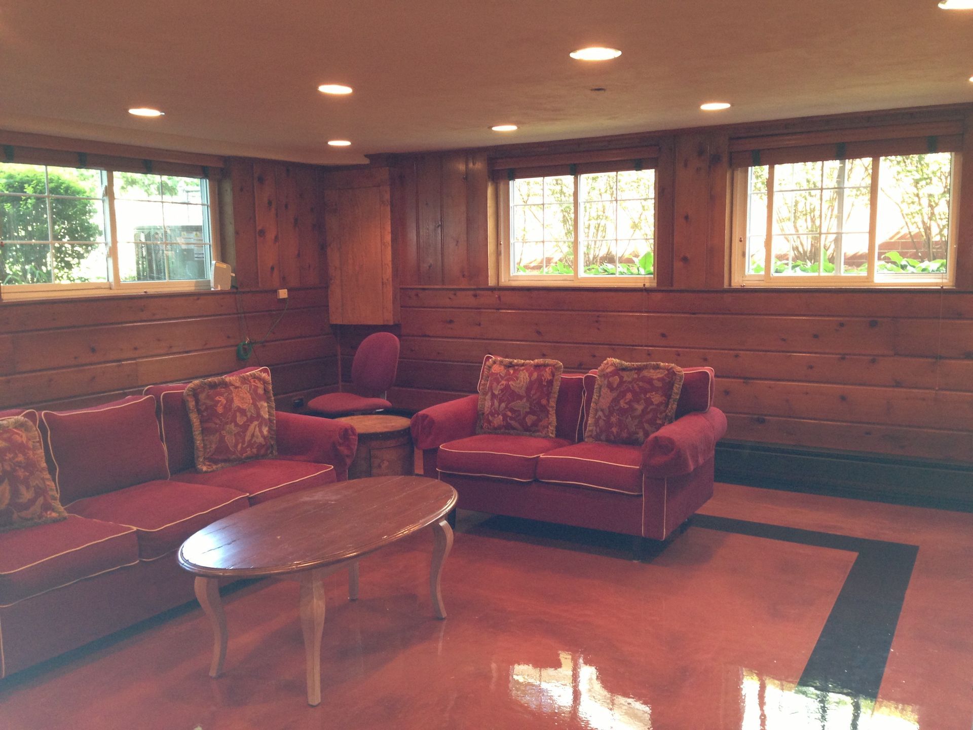 a living room with a red couch and a coffee table