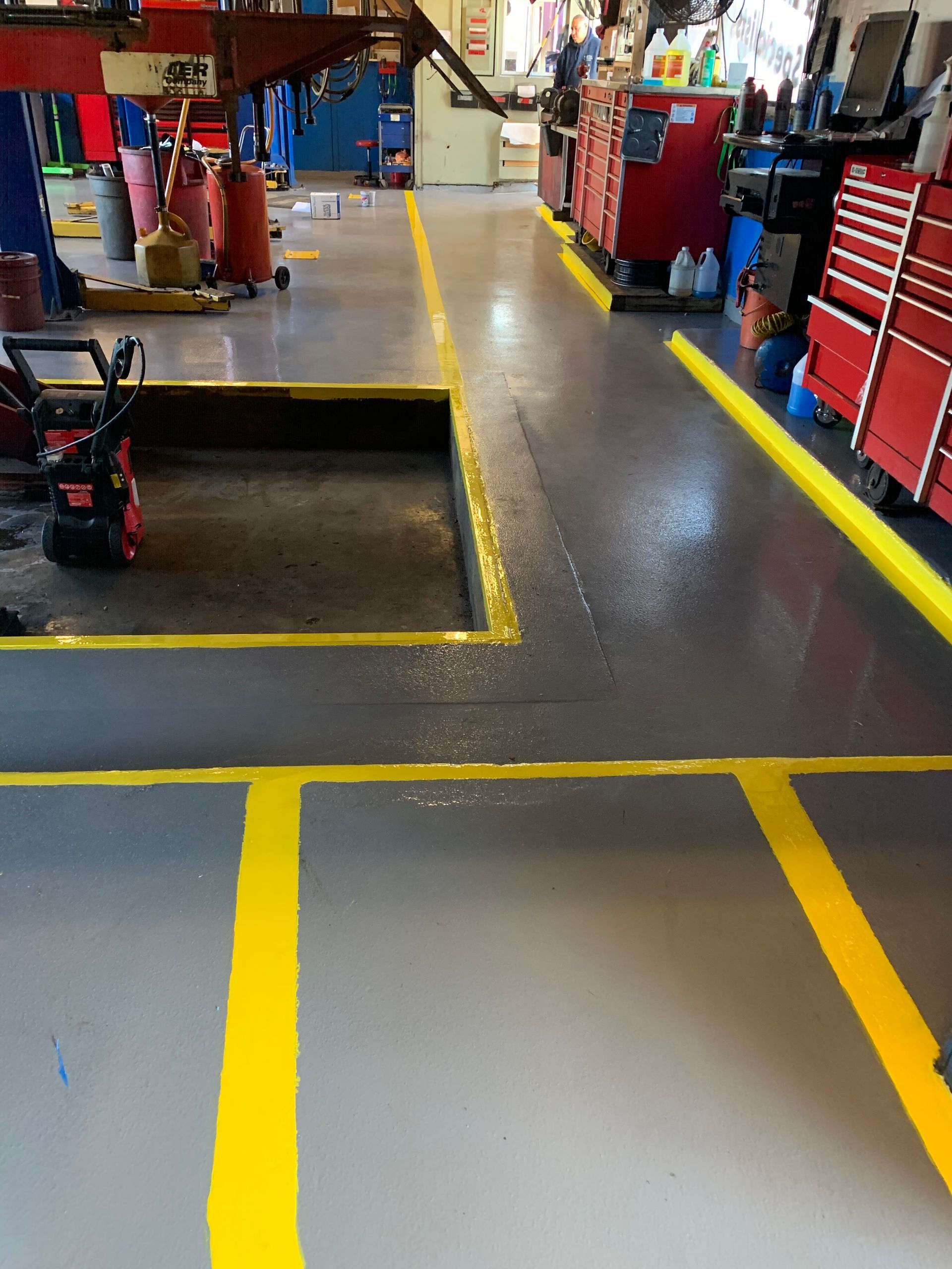 a garage with yellow lines on the floor
