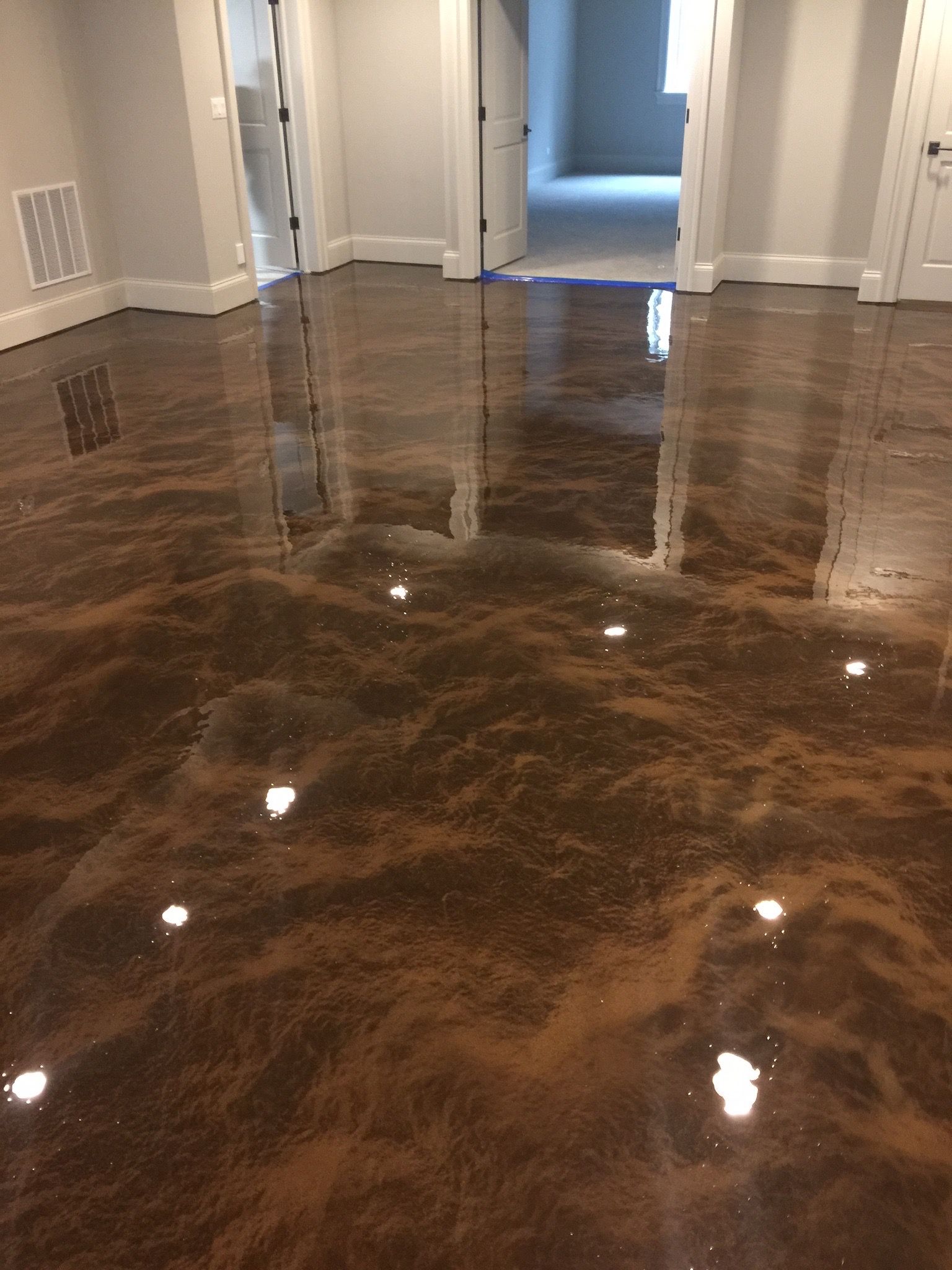 a room with a shiny metallic floor and a reflection of lights