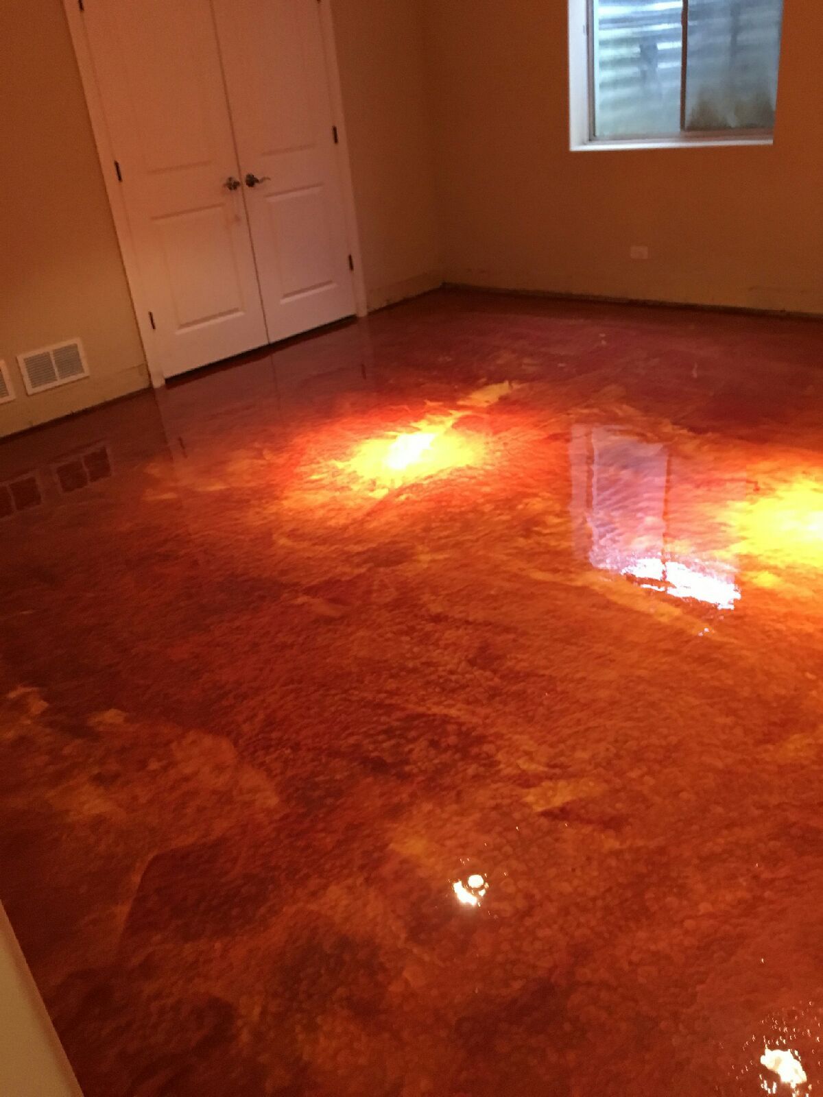 a room with a red marble floor and a window