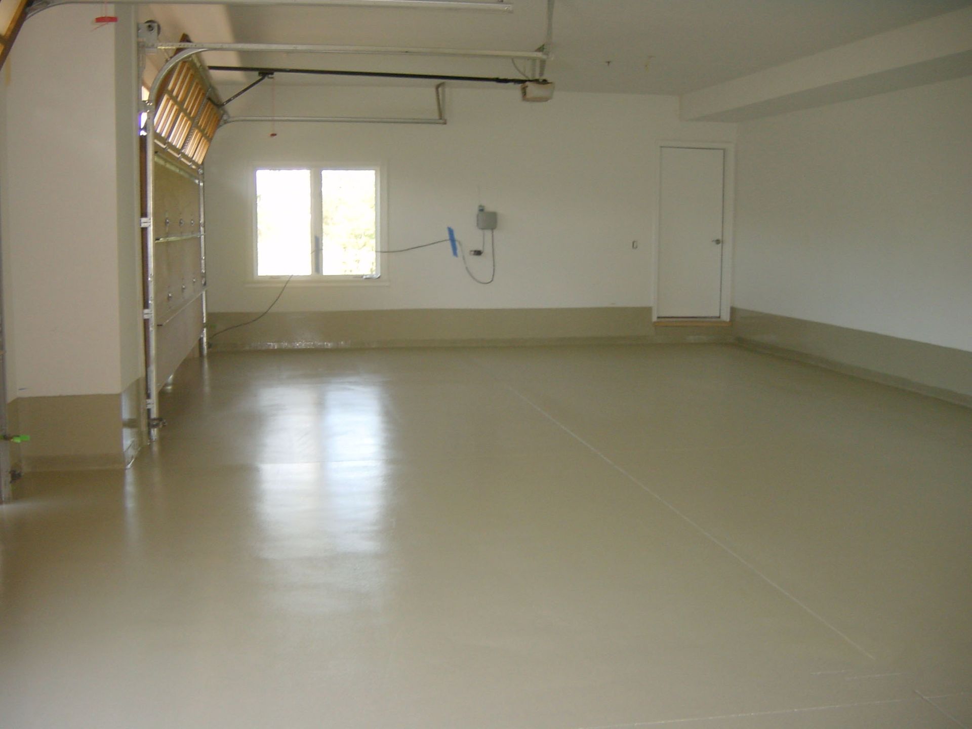 an empty garage with a white floor and white walls