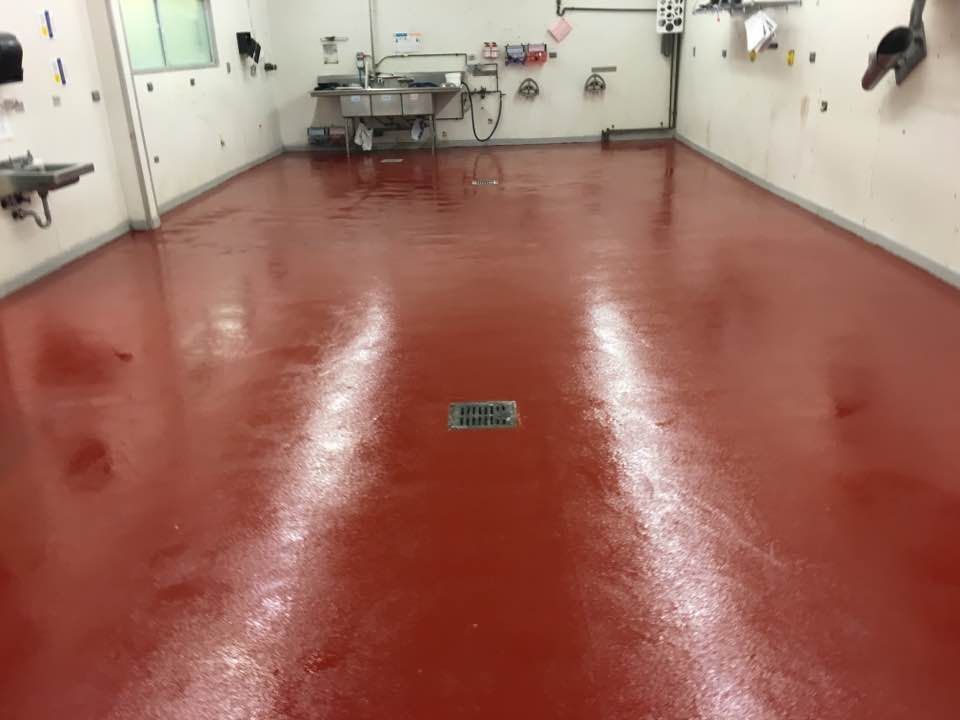 a kitchen with a red floor and a sink