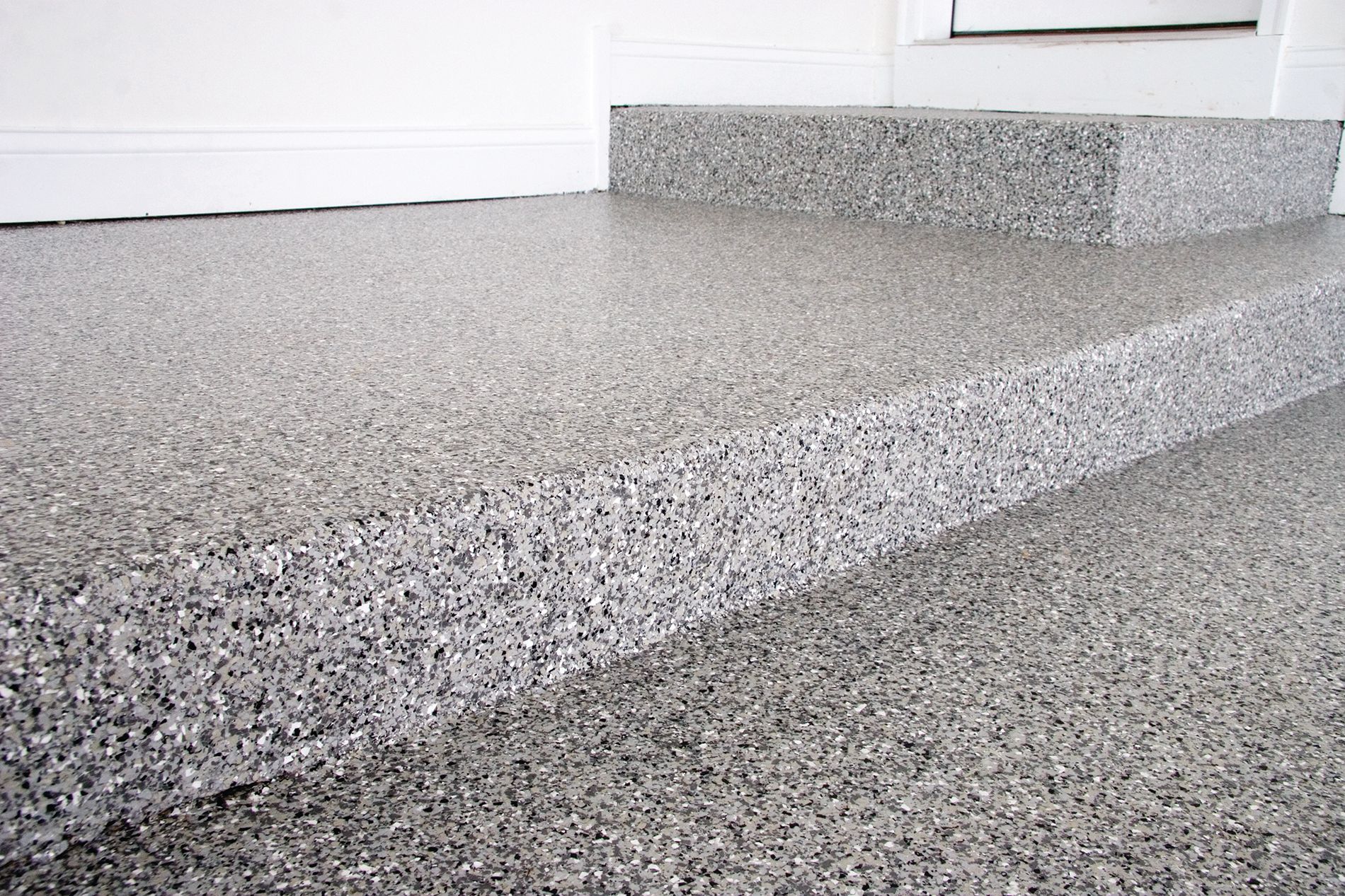 a close up of a gray concrete floor next to a door