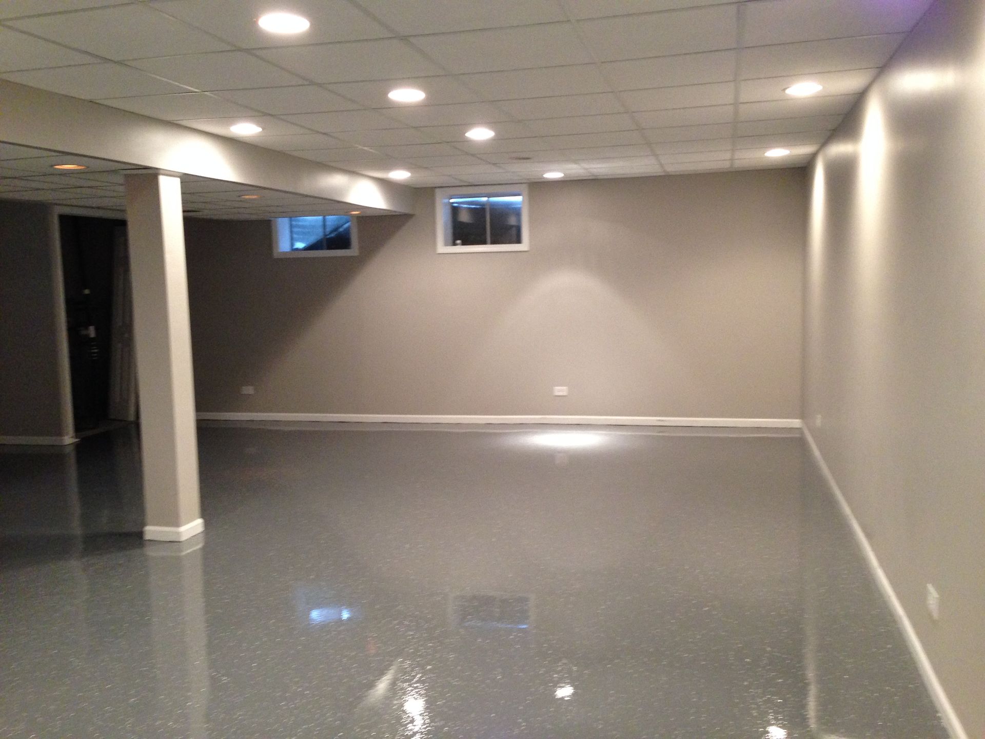 an empty basement with a window on the ceiling