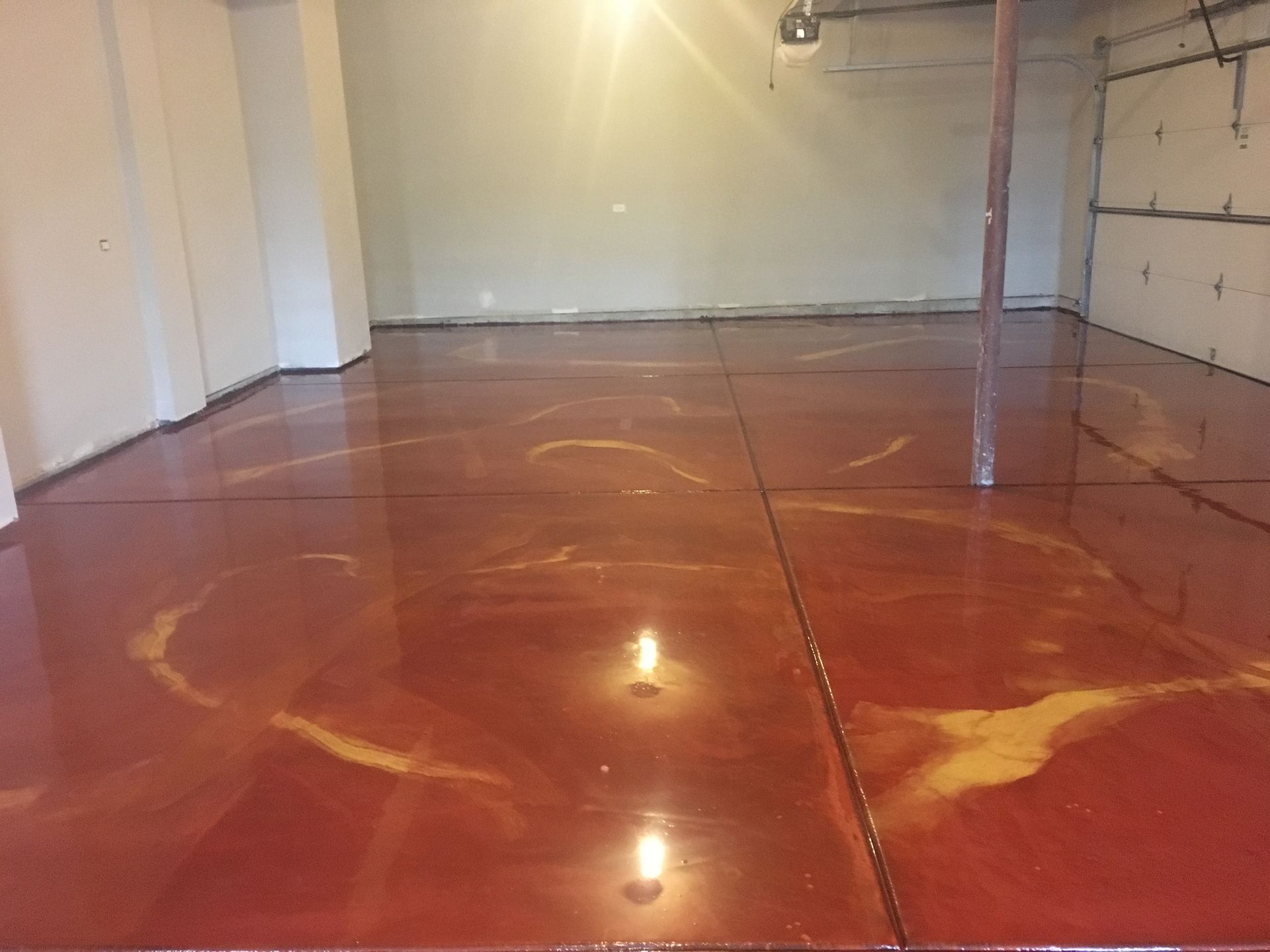 a red and gold colored concrete floor in a garage