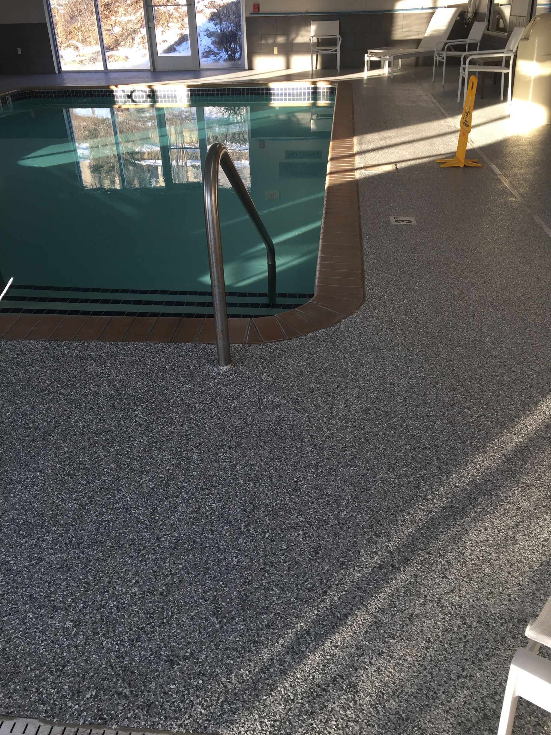 a large indoor swimming pool with a staircase leading to it