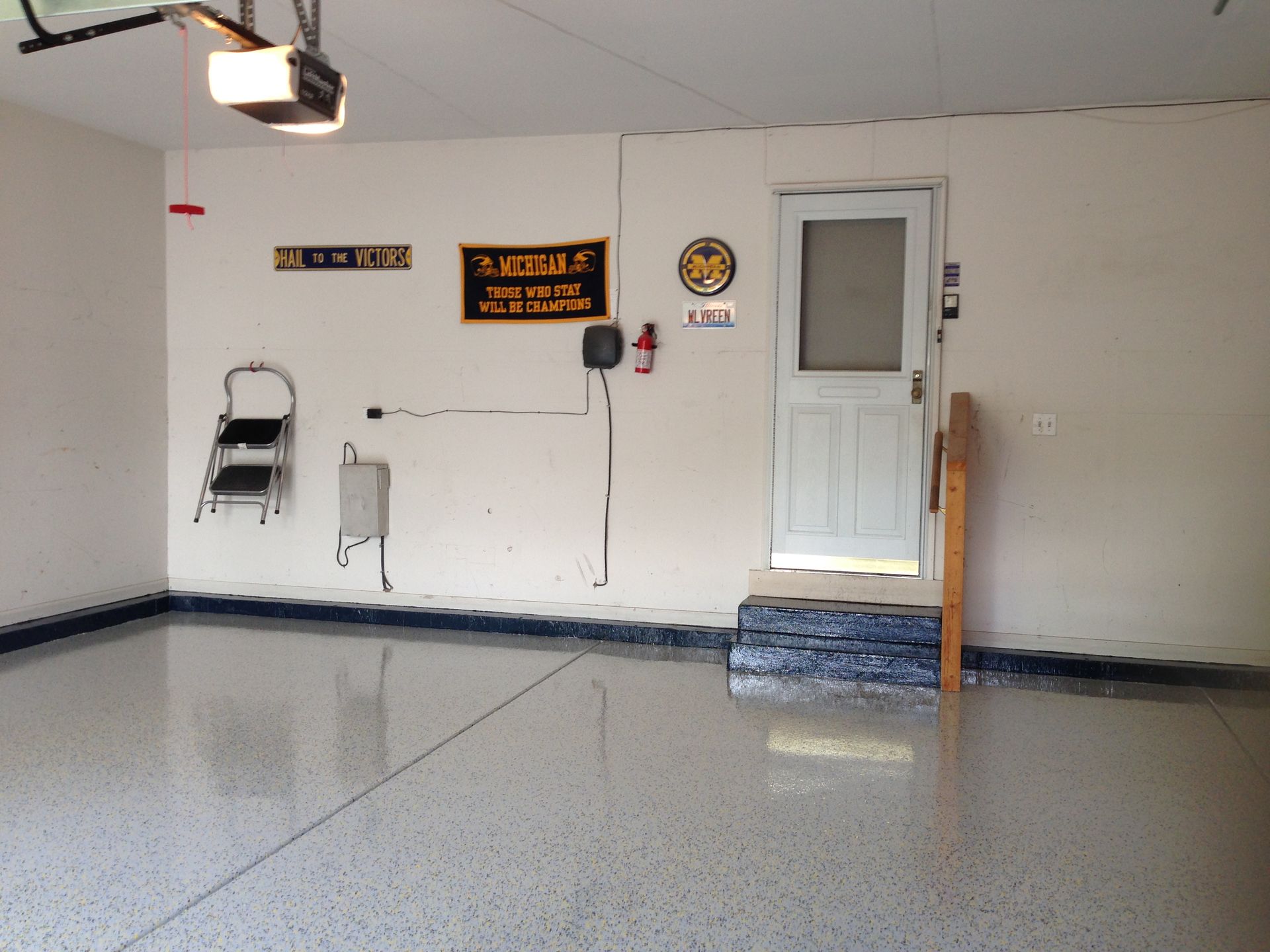 an empty garage with a sign on the wall