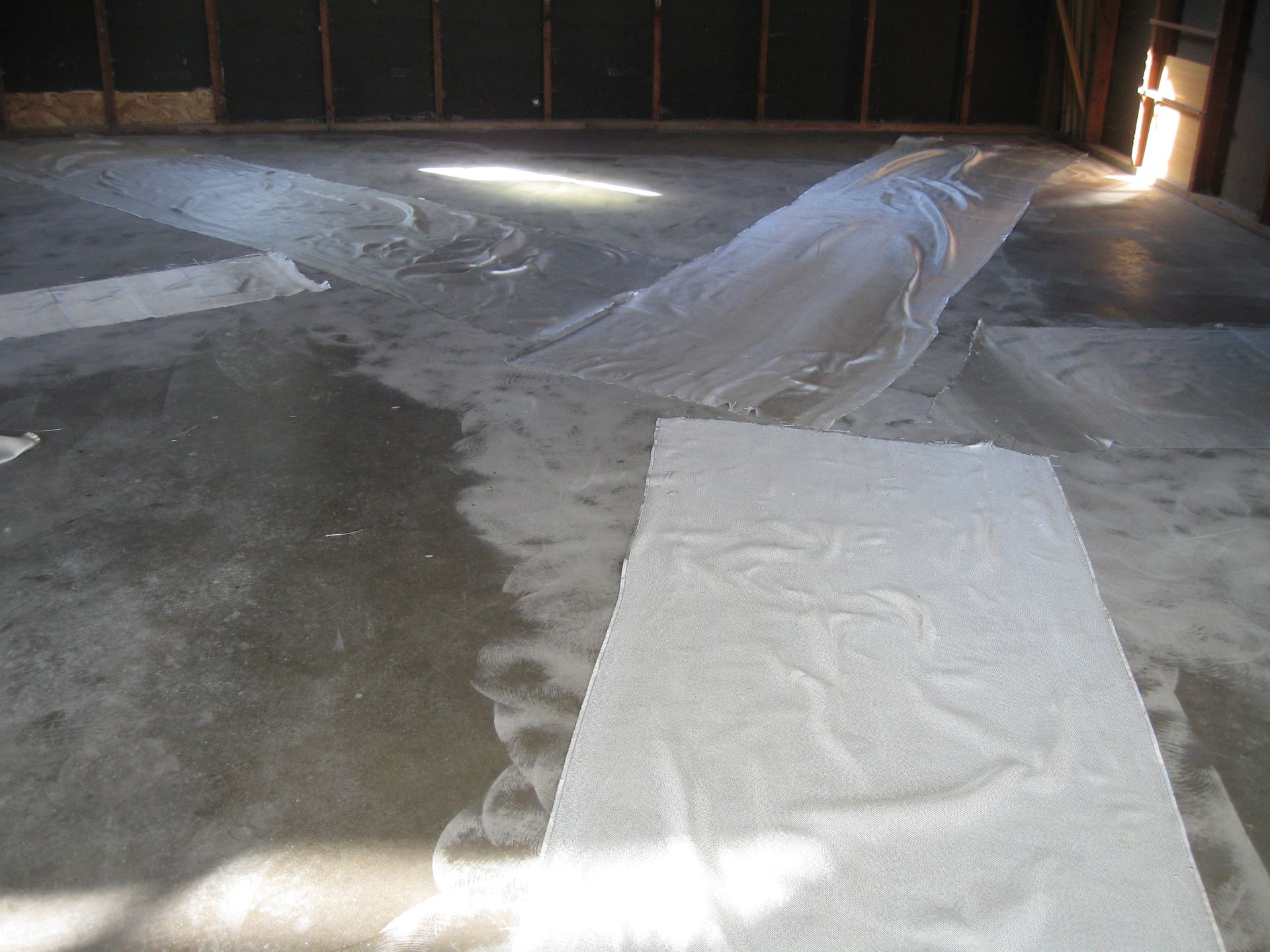 a white towel is laying on a concrete floor