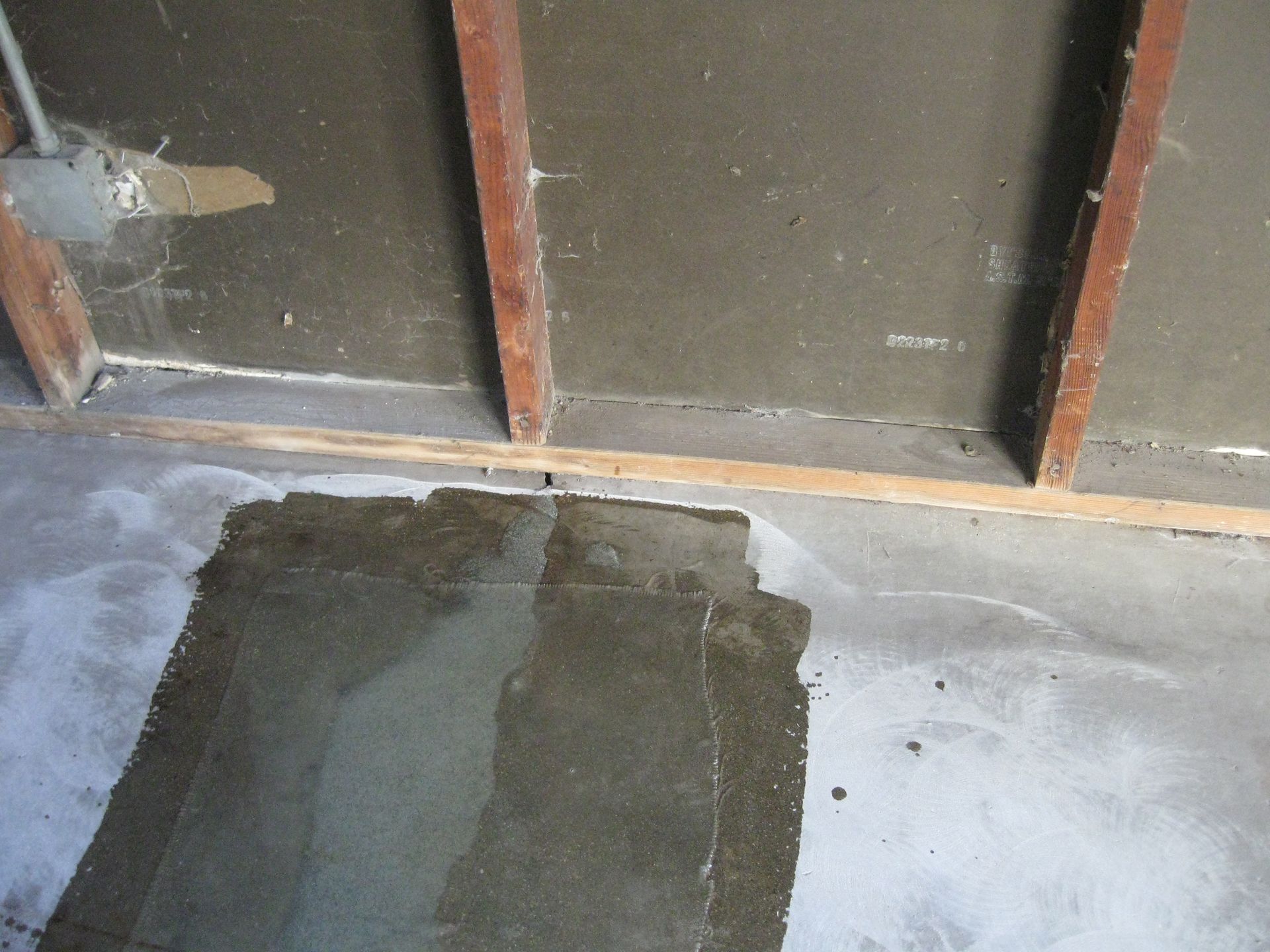 a piece of concrete is on the floor in front of a wall