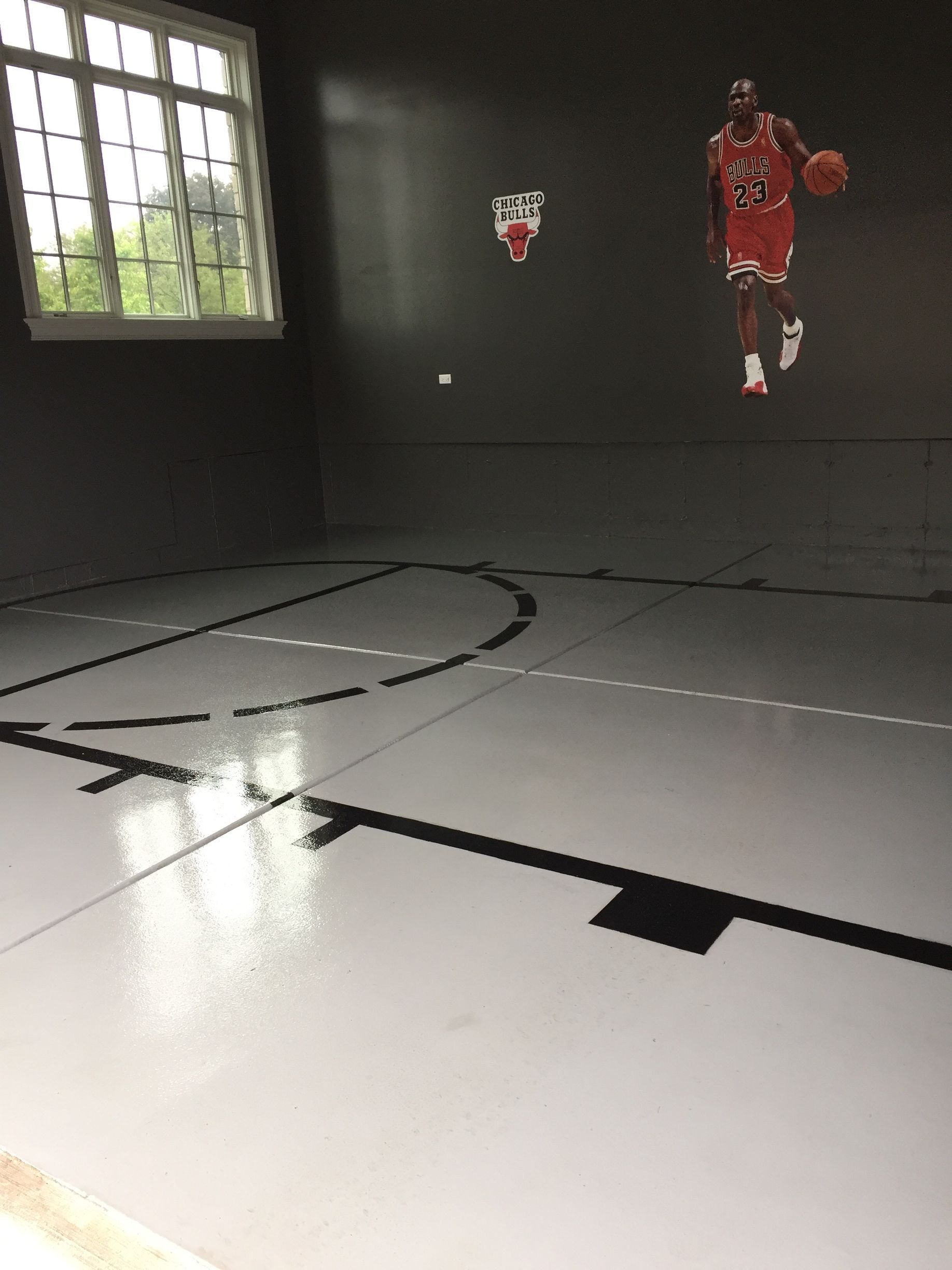 a basketball court with a picture of michael jordan on the wall
