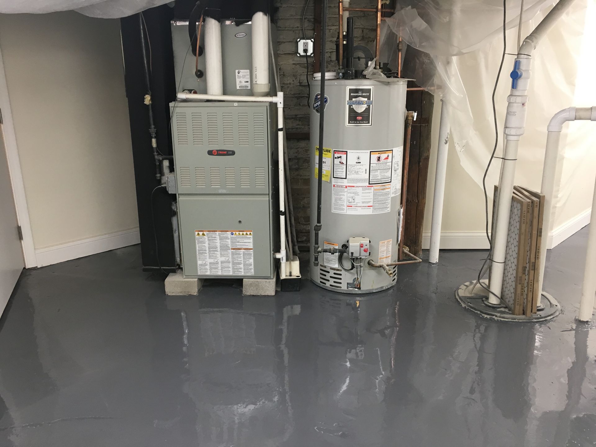 a basement with a water heater and a furnace