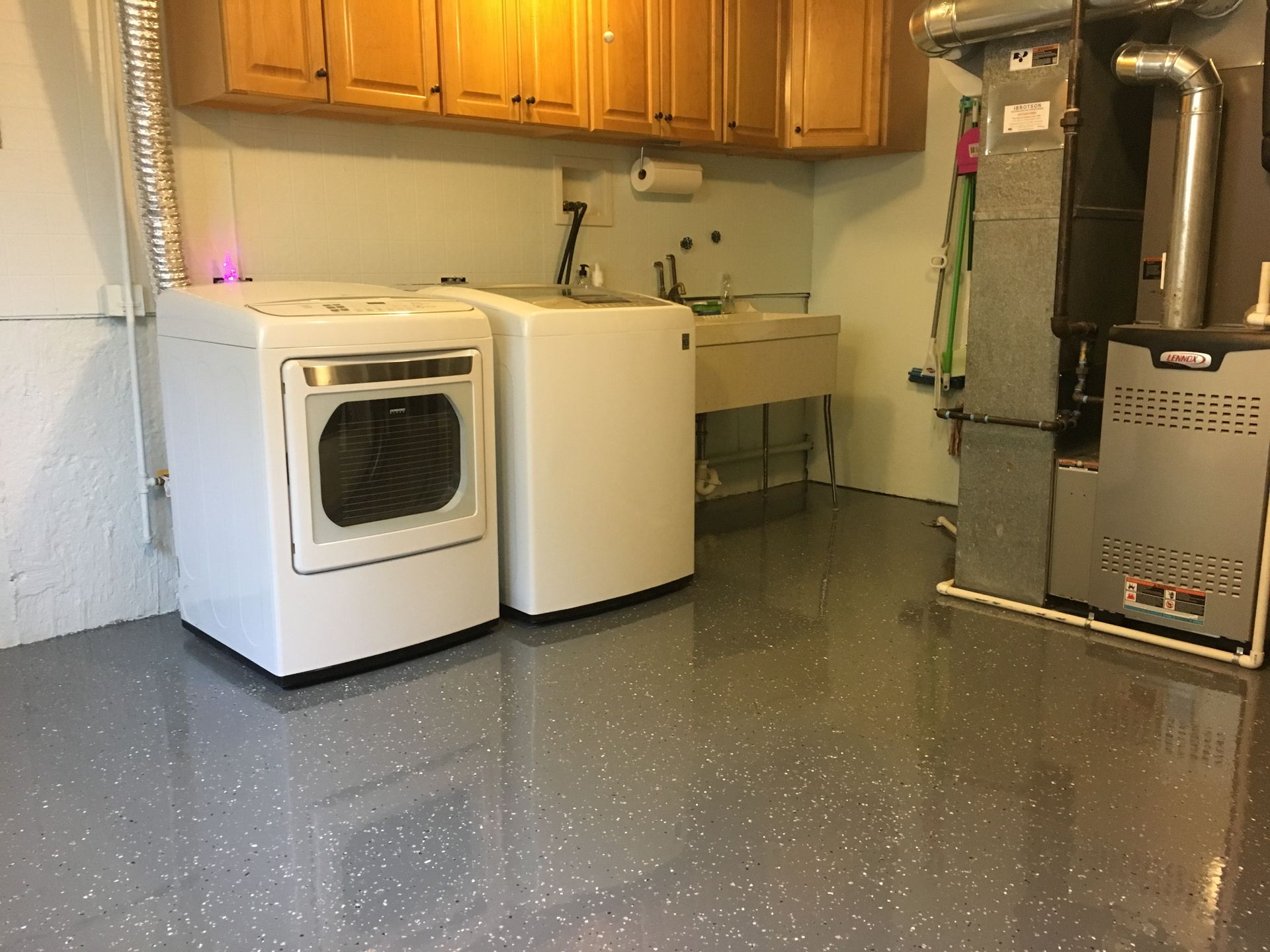 a laundry room with a washer and dryer and a sink
