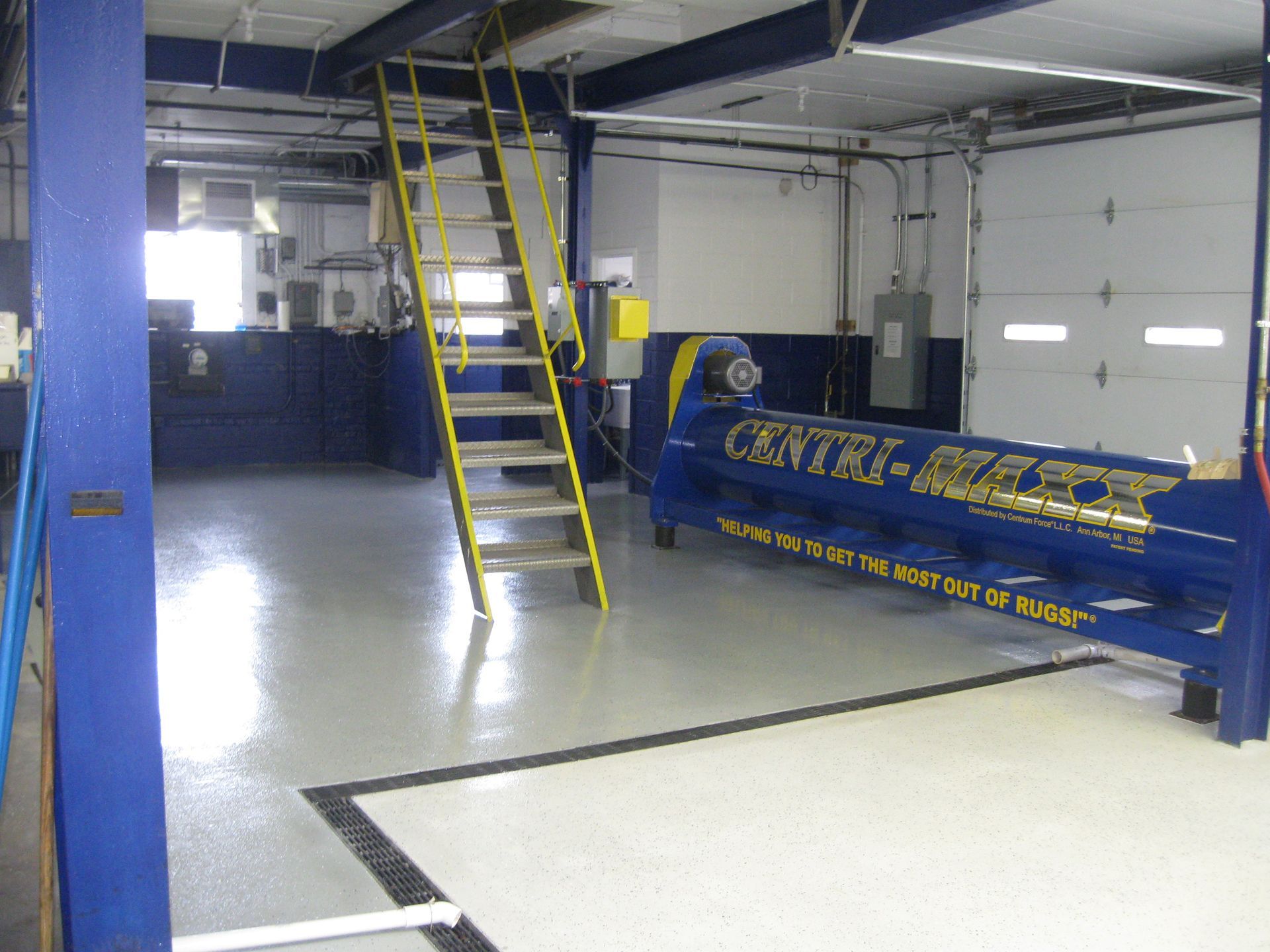 a blue center-place machine is in a garage