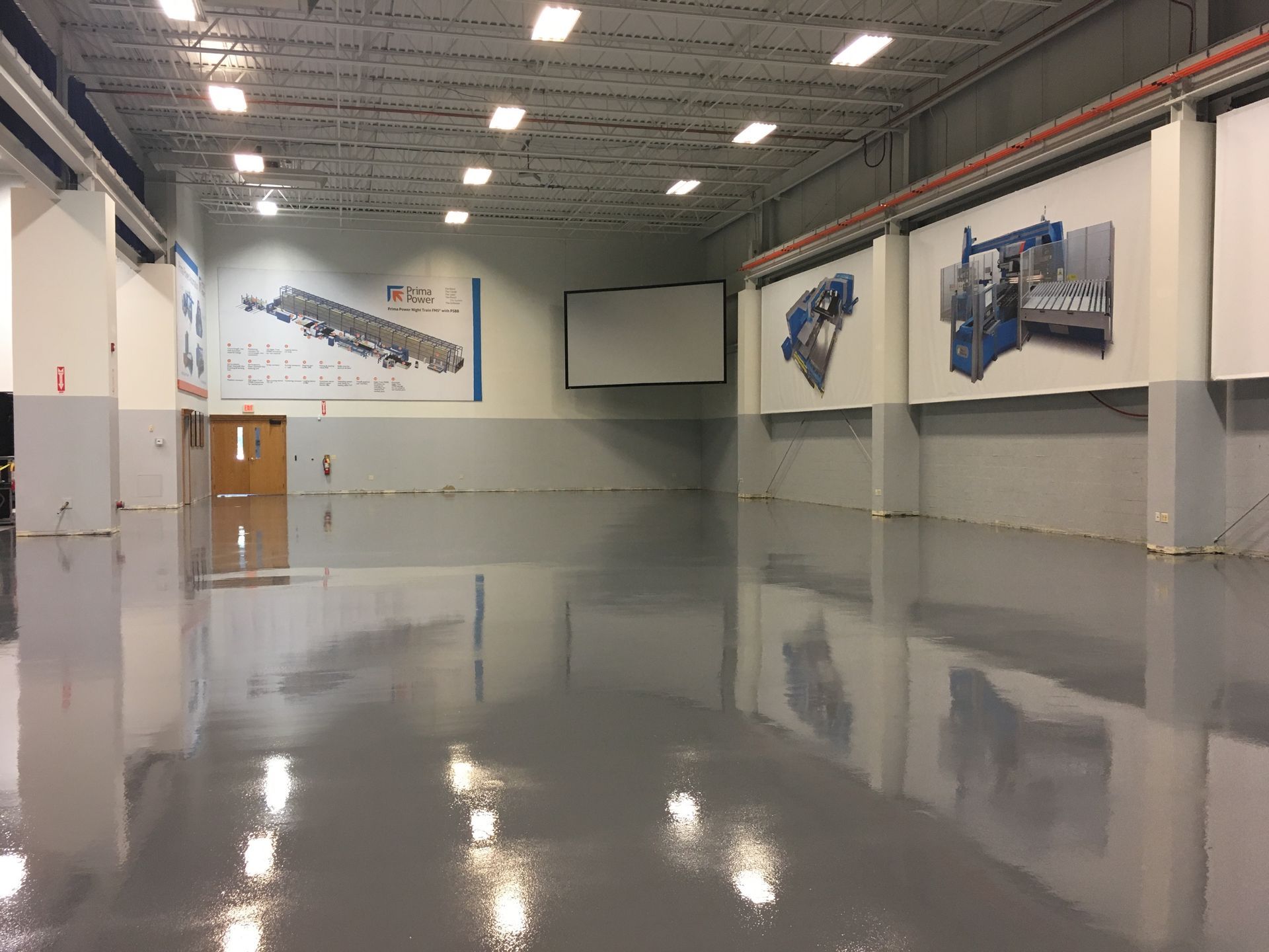 a large empty warehouse with a shiny concrete floor