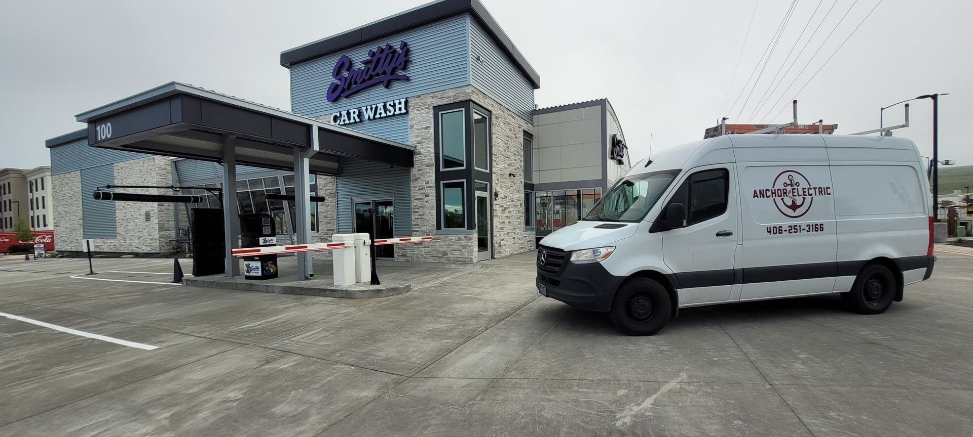 White service van parked outside a car wash, 