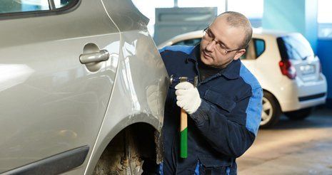 Learn more about full body shop Man fixing auto body
