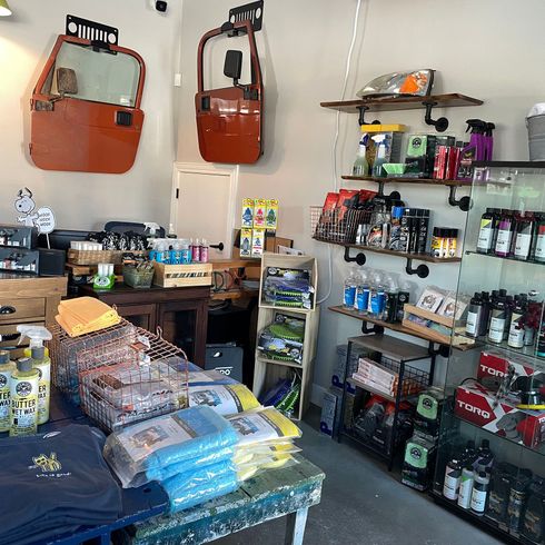 A store filled with lots of products including a jeep door