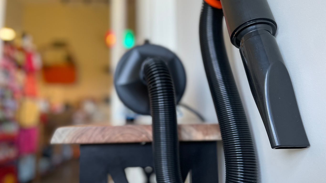 A close up of a vacuum cleaner attached to a wall