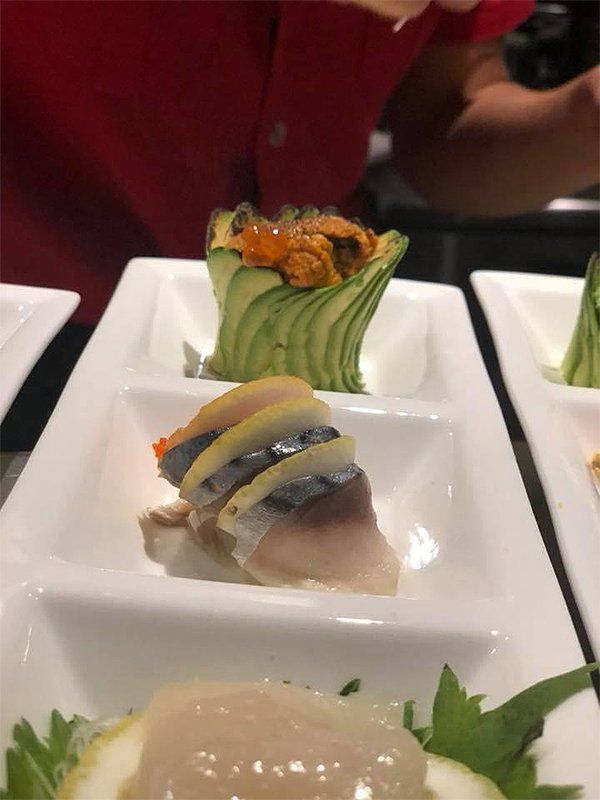 A close up of a plate of food with a person in the background