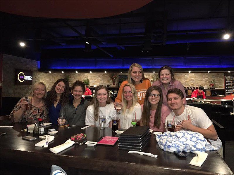 A group of people are sitting at a table in a restaurant.