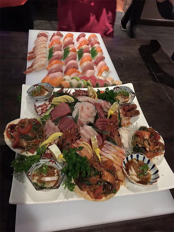 A tray of sushi and other food on a table