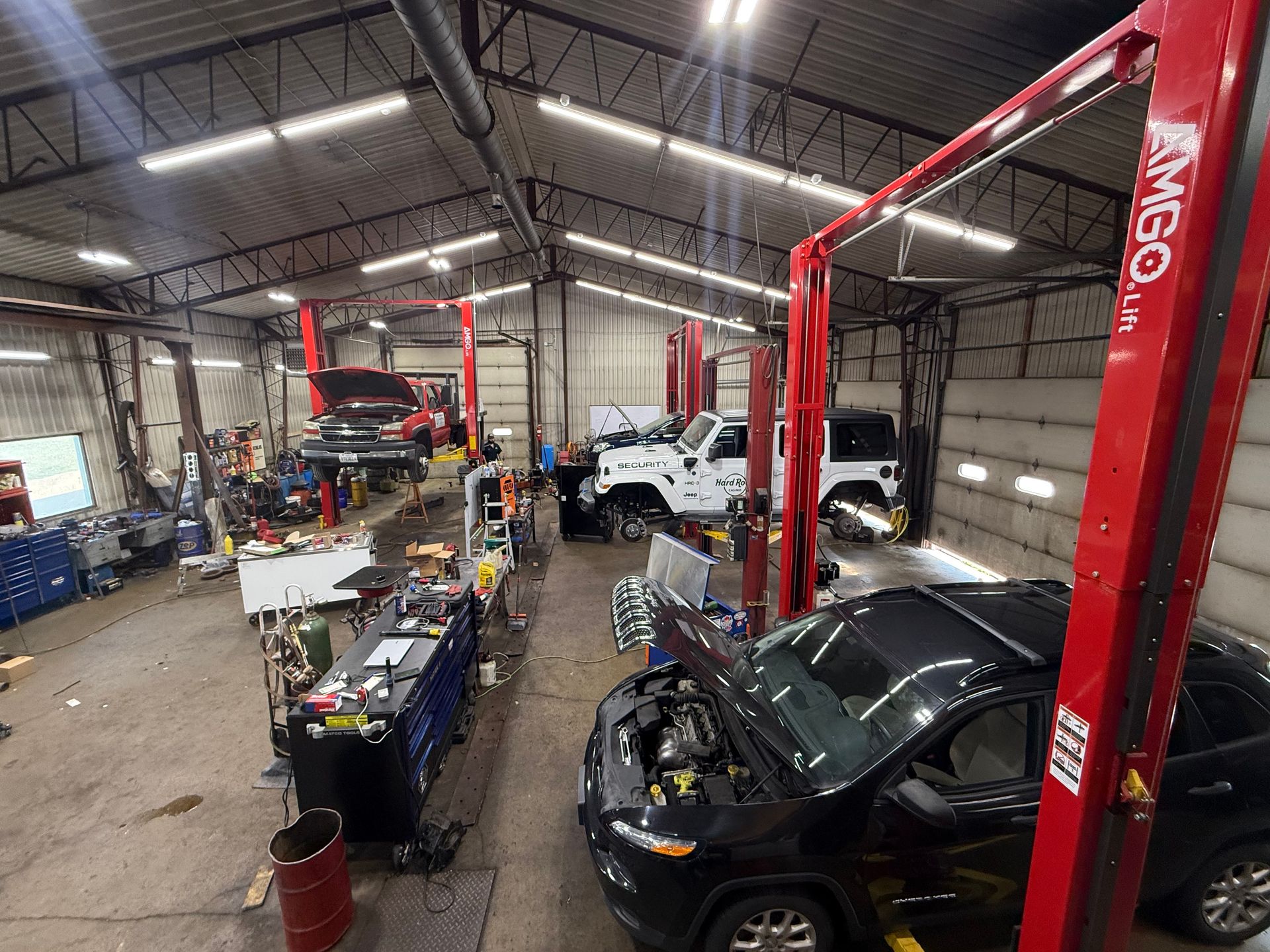 A car is sitting on a lift in a garage.