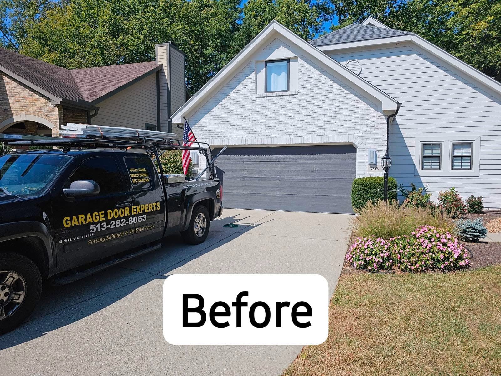 Before photo of a white house with a gray garage and a black work van in the driveway