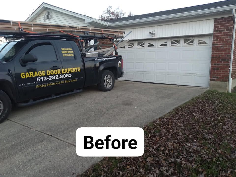 Garage door repair truck parked in driveway beside a white garage, labeled “Before”